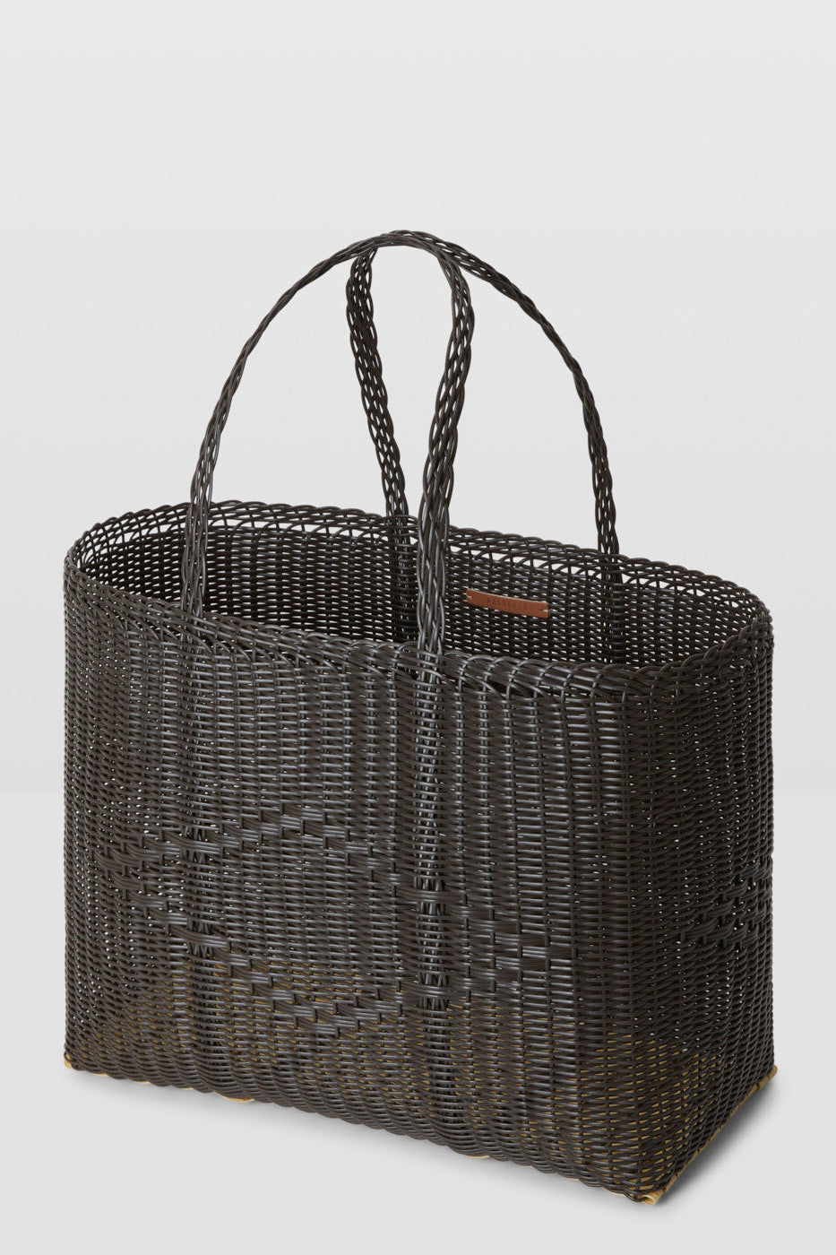 Black woven tote bag on a light gray background