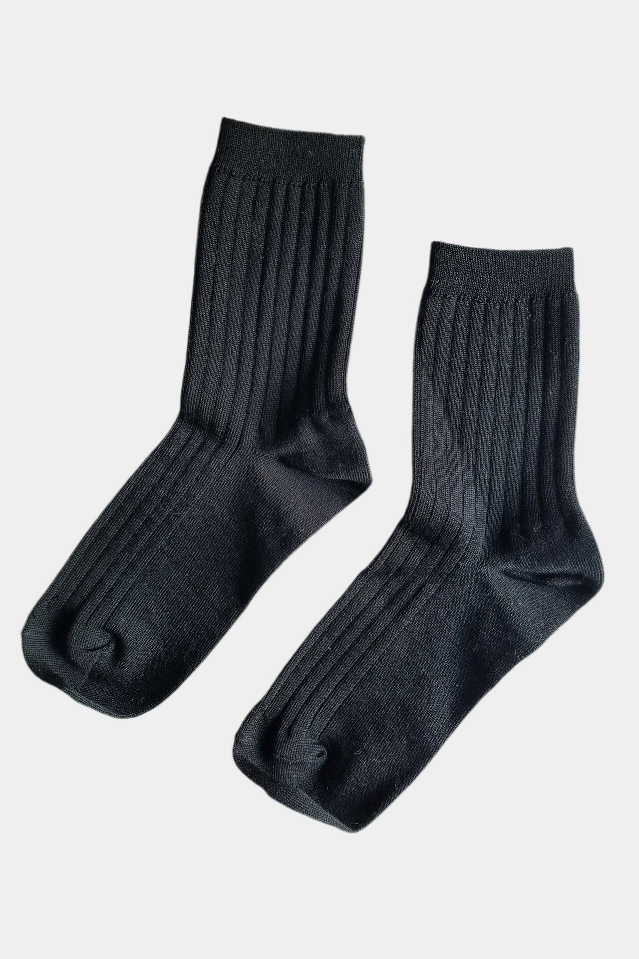 Black socks with a white label on a light gray background