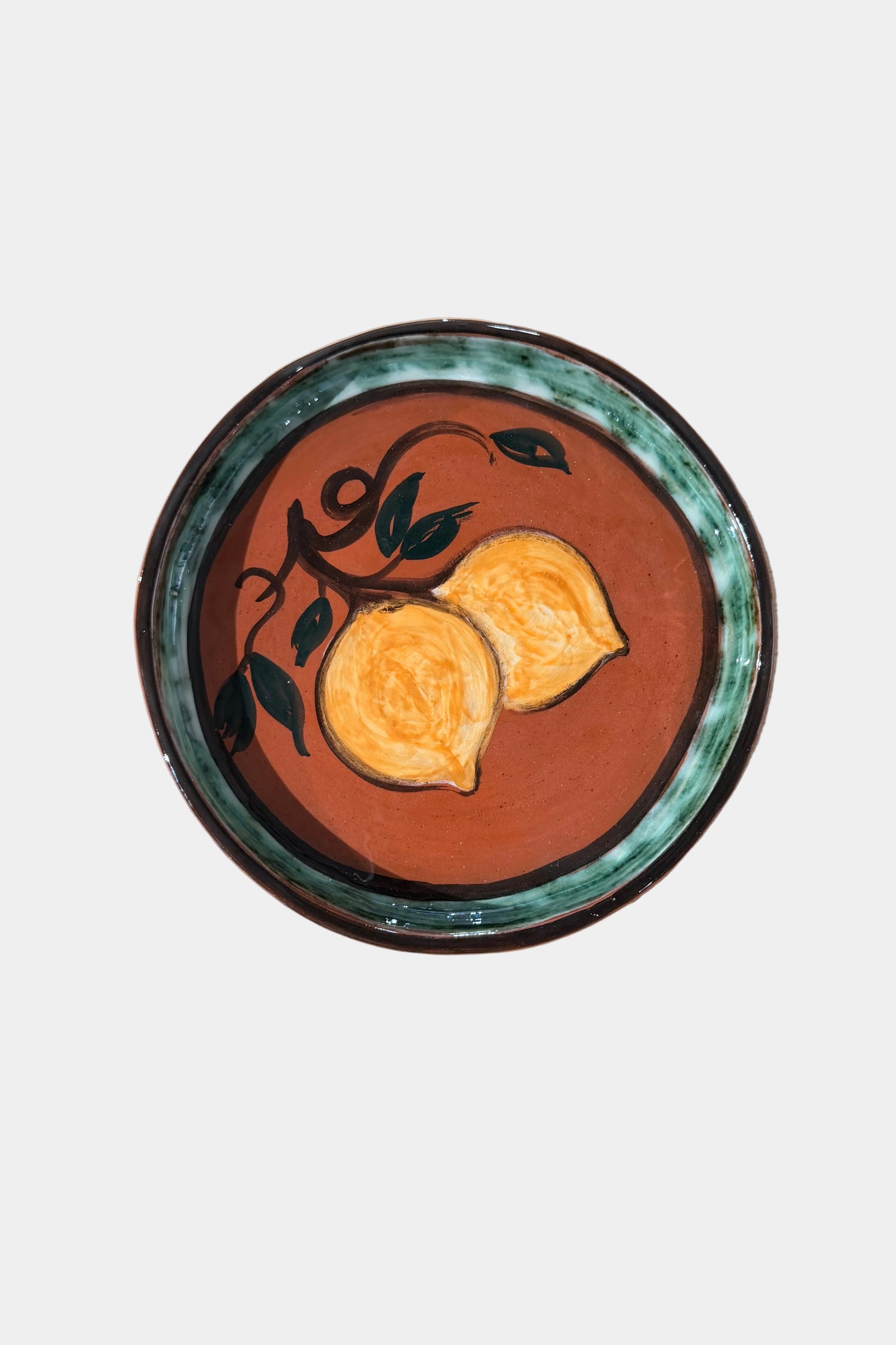 Decorative plate with lemon design on a plain background