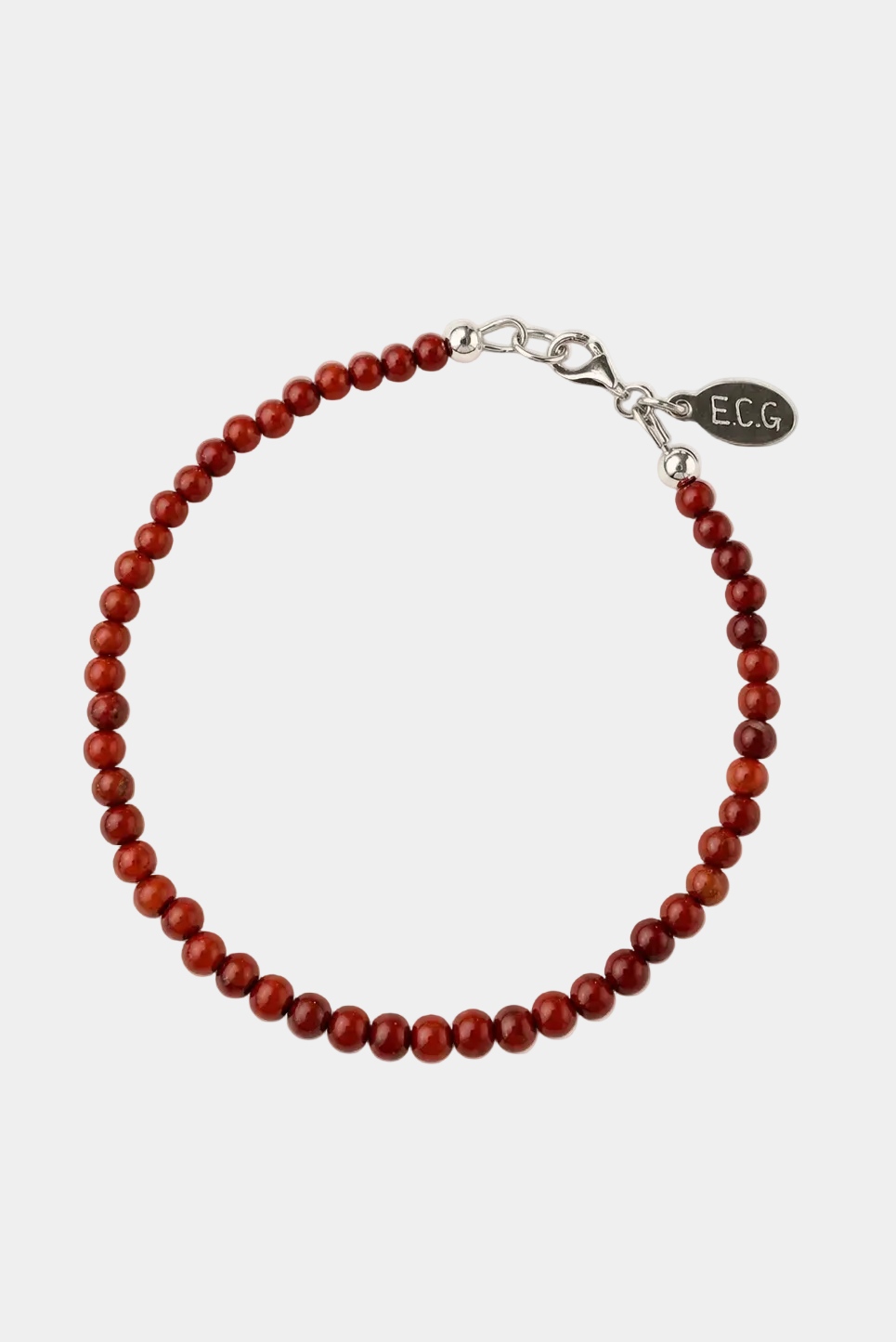 Red beaded bracelet with silver clasp on a white background
