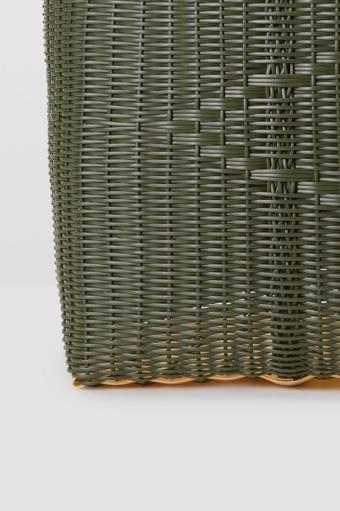 Close-up of a green woven mat on a white background