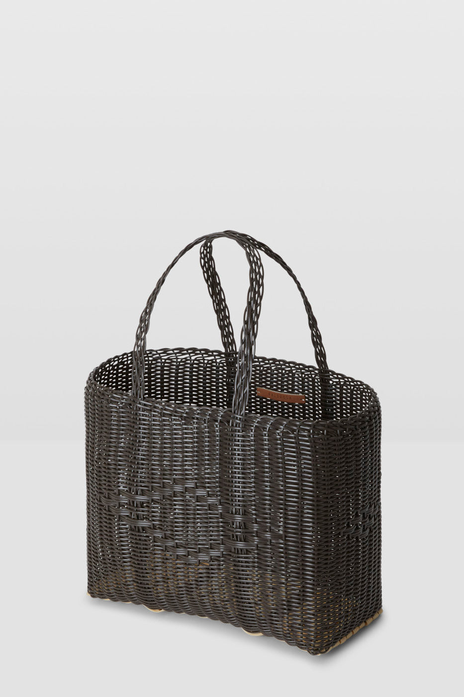 Black woven tote bag on a light gray background