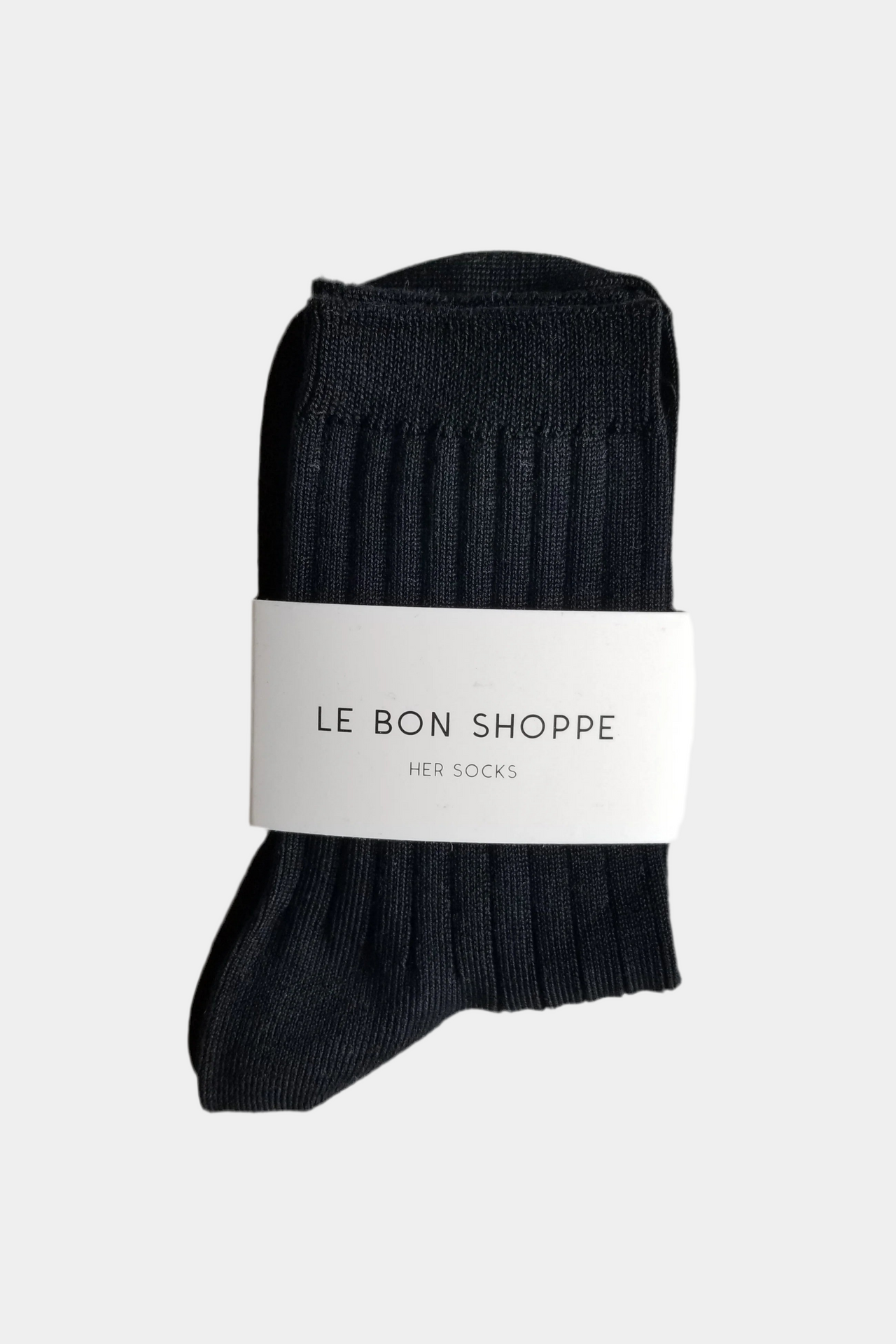 Black socks with a white label on a light gray background