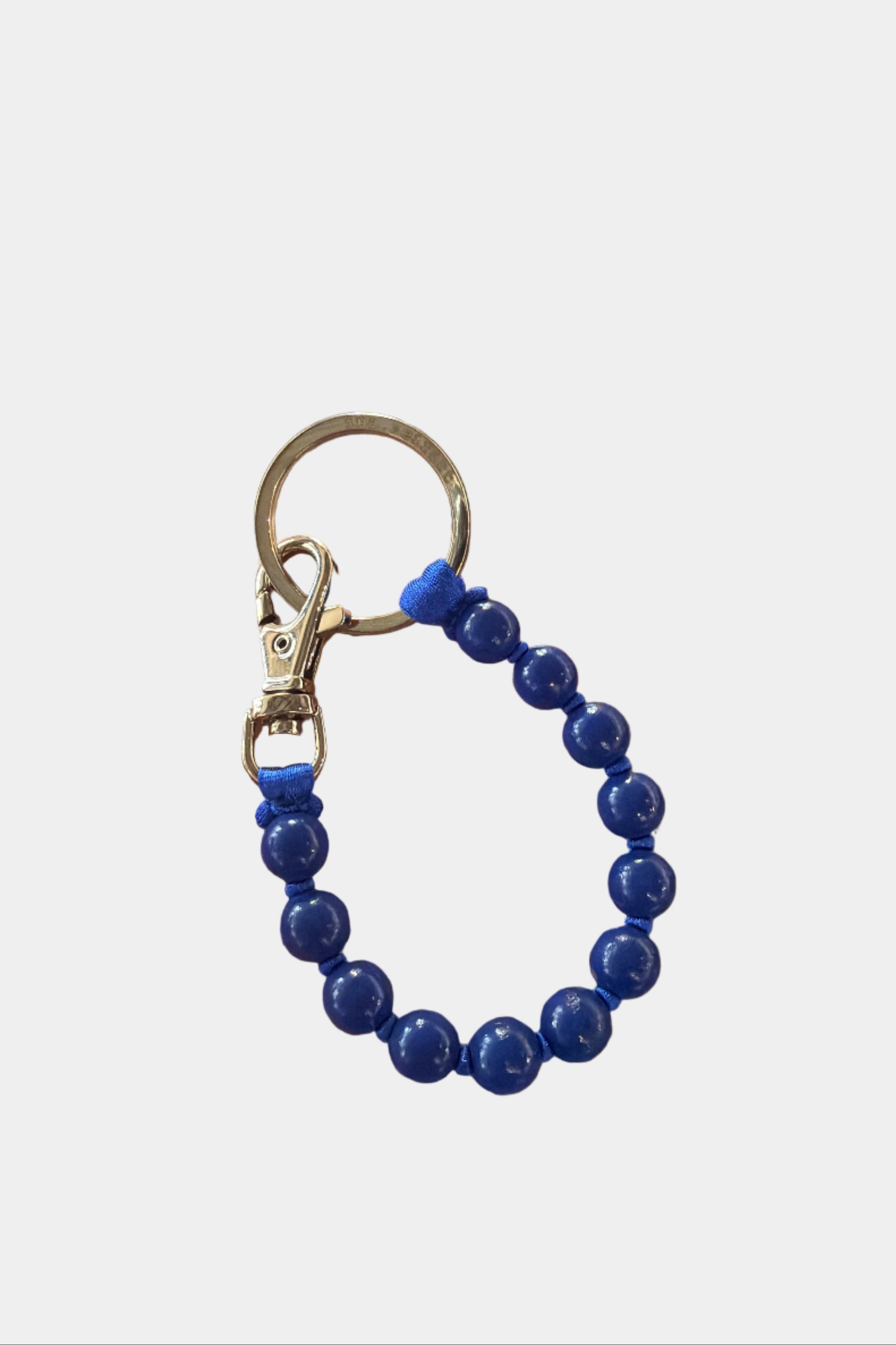 Blue beaded wooden keyring with silver hardware against a white background.