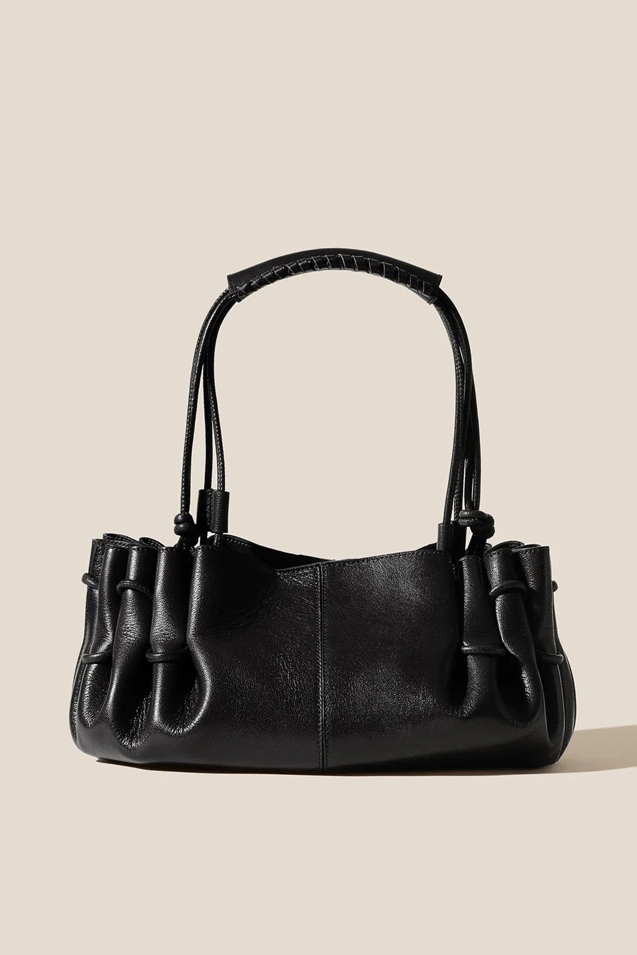 Black handbag on a beige background