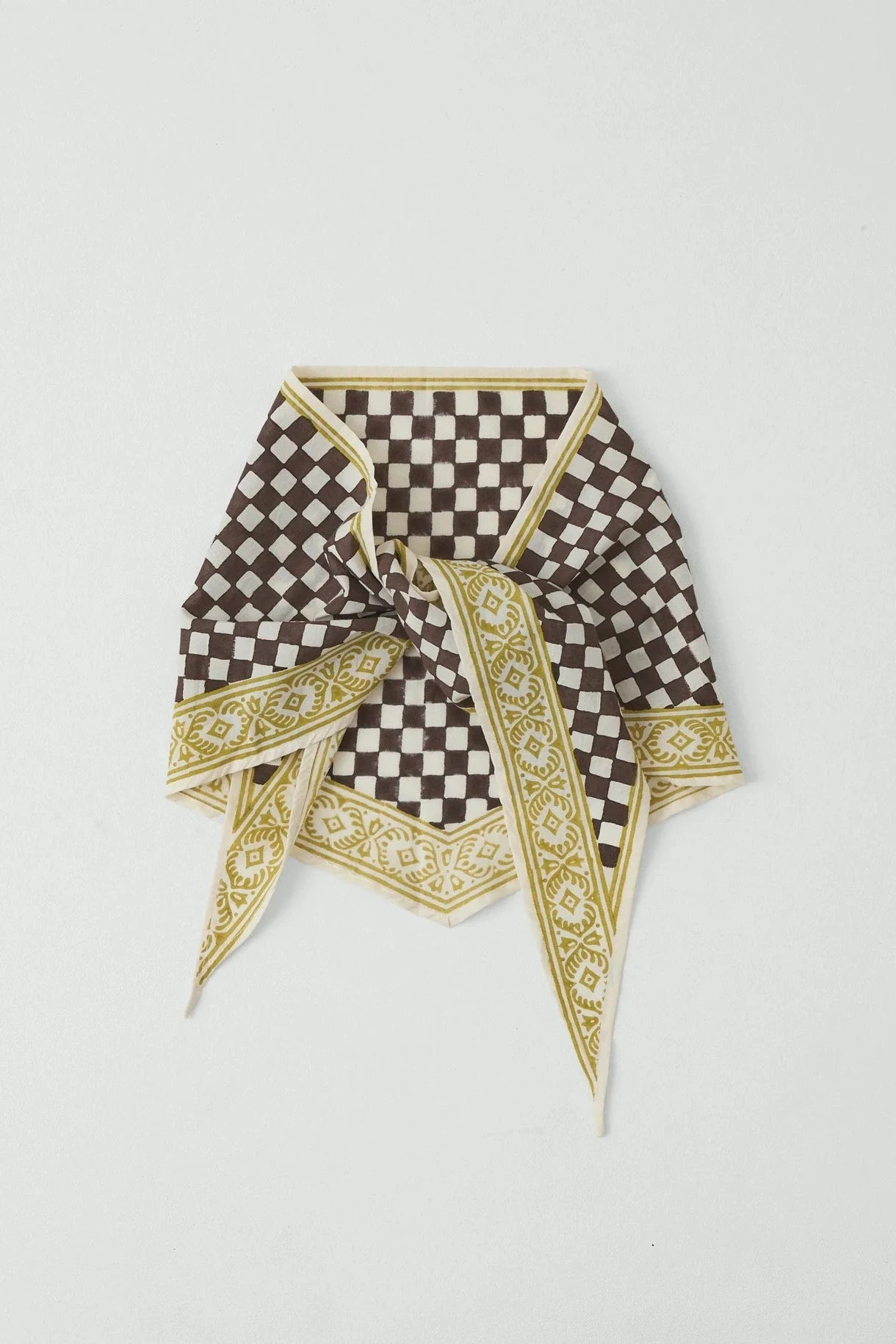 Checkered scarf with decorative border on a light gray background