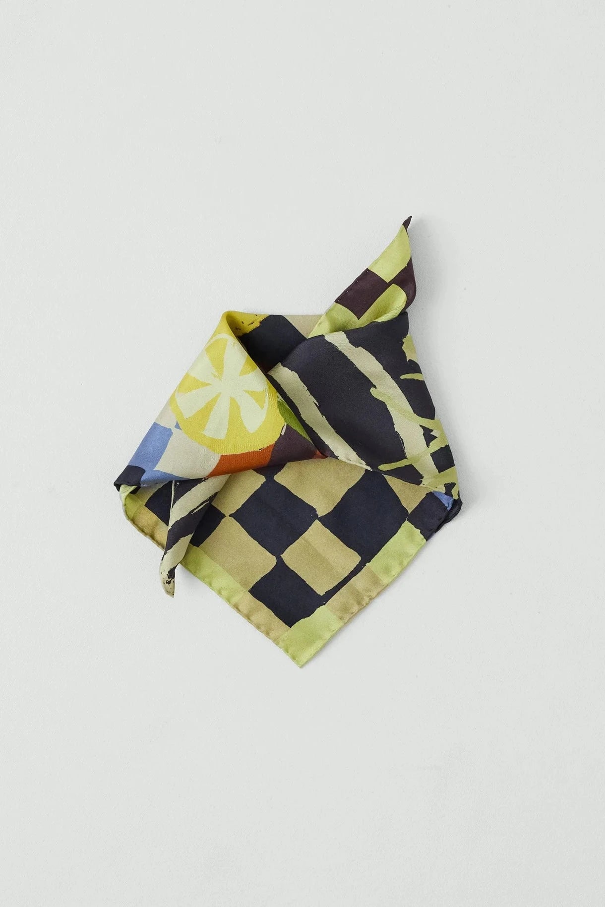 Folded fabric with geometric pattern on a light gray background