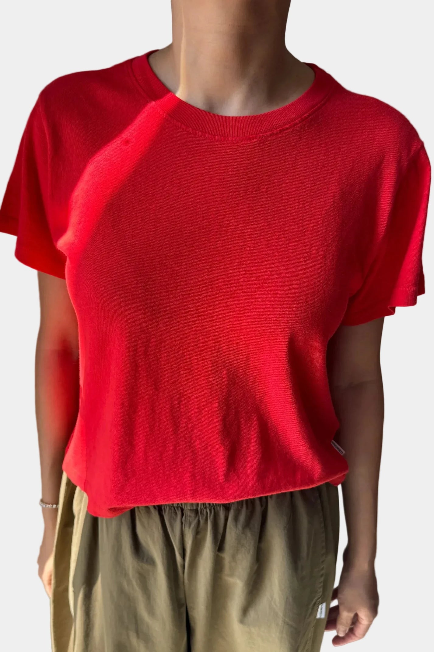 A person wearing the Le Bon Shoppe Airy Tee in tomato, viewed for the front - East Coast General