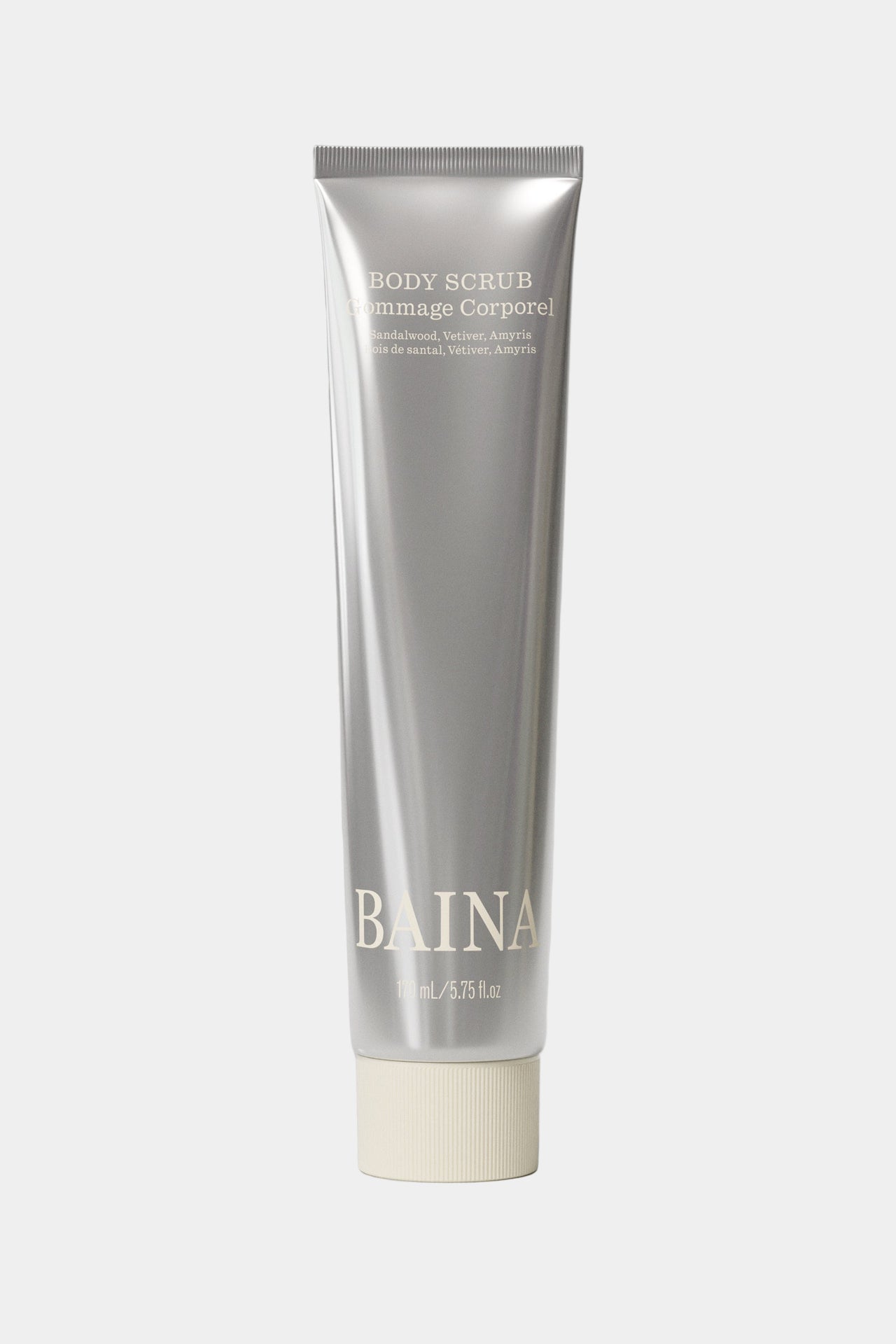 Silver tube of Baina body scrub on a light gray background