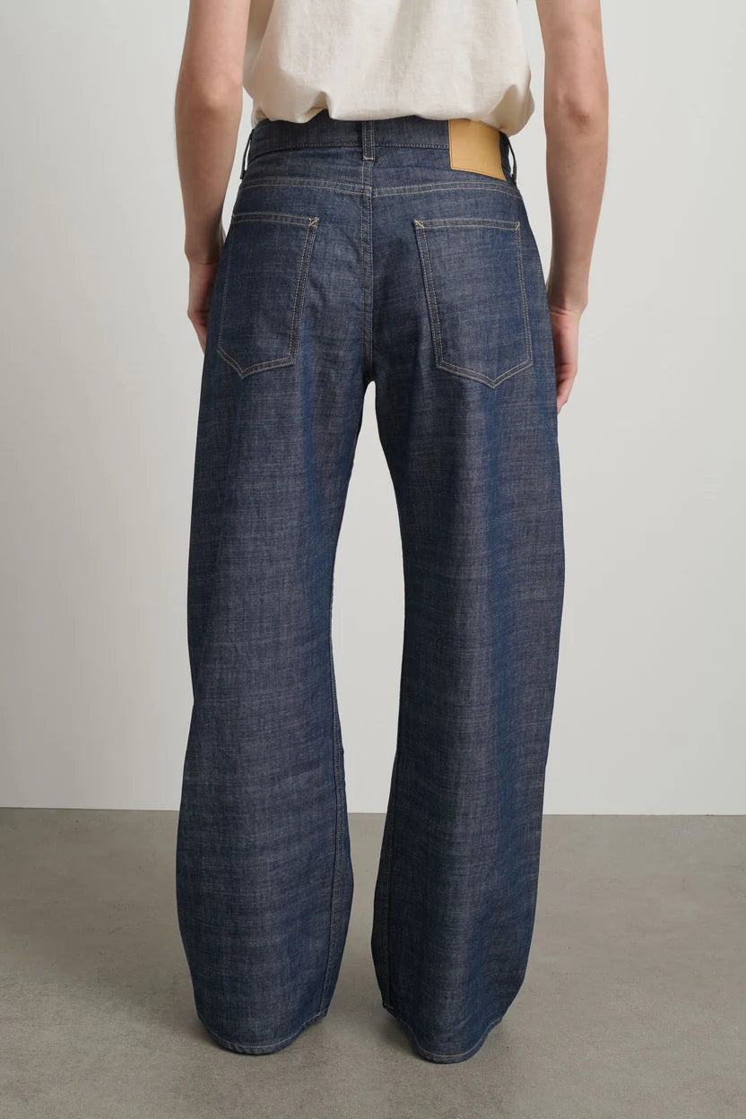 Person wearing wide-leg jeans against a plain background