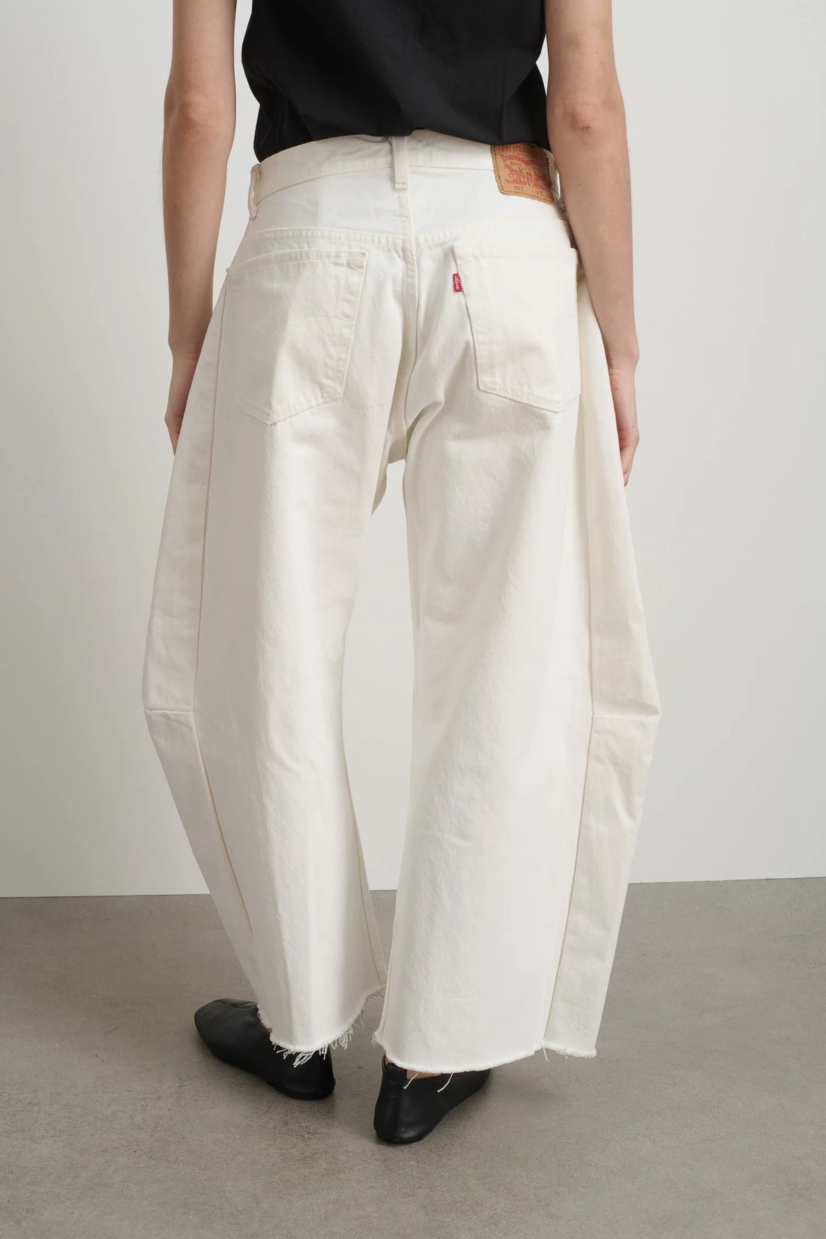 Person wearing B Sides Jeans Vintage lasso in White back view - East Coast General