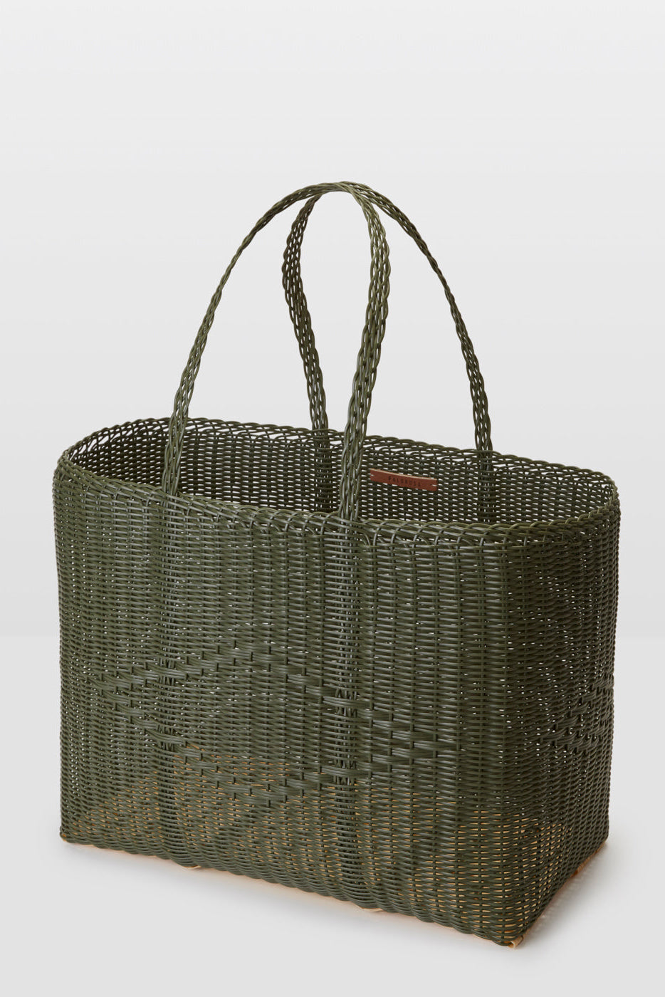 Woven green tote bag on a light gray background