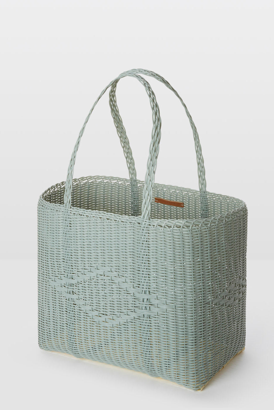 Woven basket with handles on a white background
