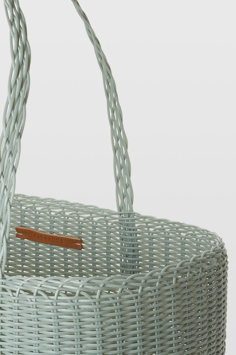 Eucalyptus woven  basket with a handle on a light gray background