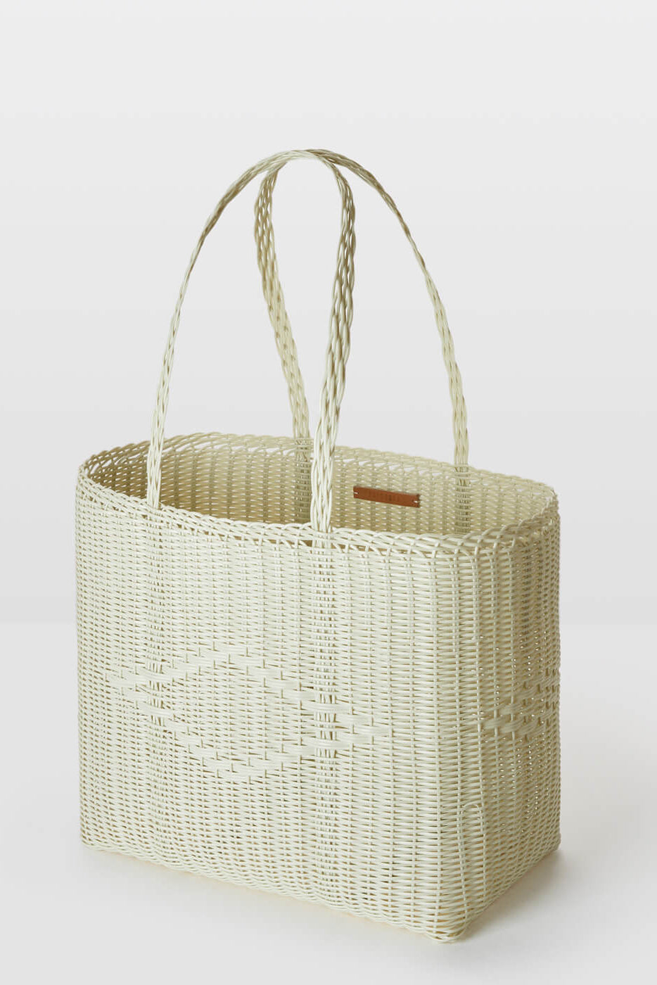 Woven basket with handles on a white background