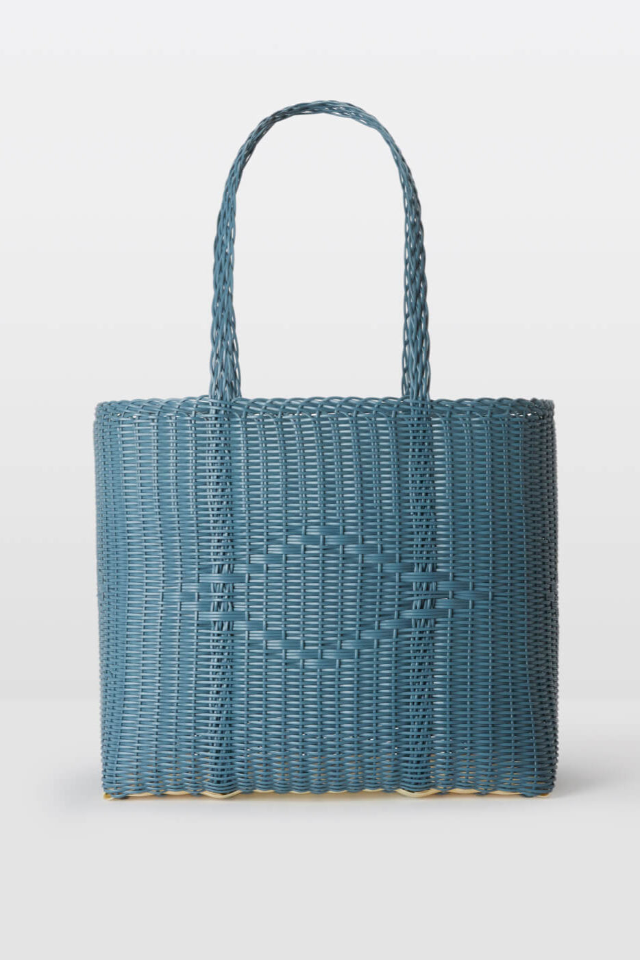 Blue woven handbag on a light gray background
