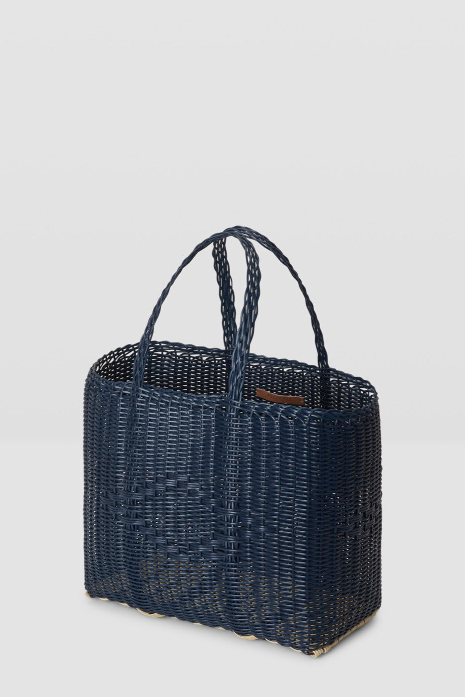 Black woven handbag on a light gray background