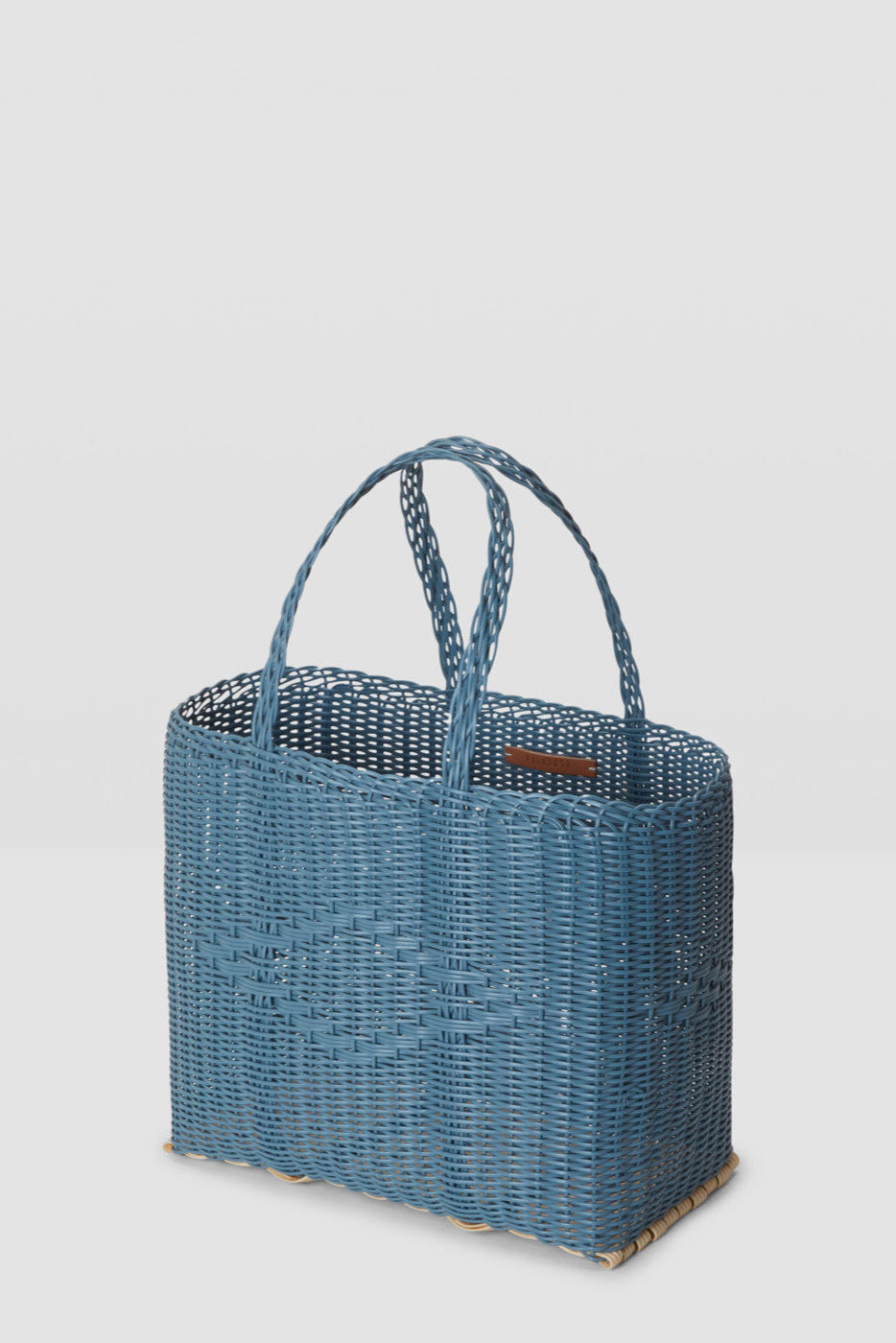 Blue woven handbag on a light gray background