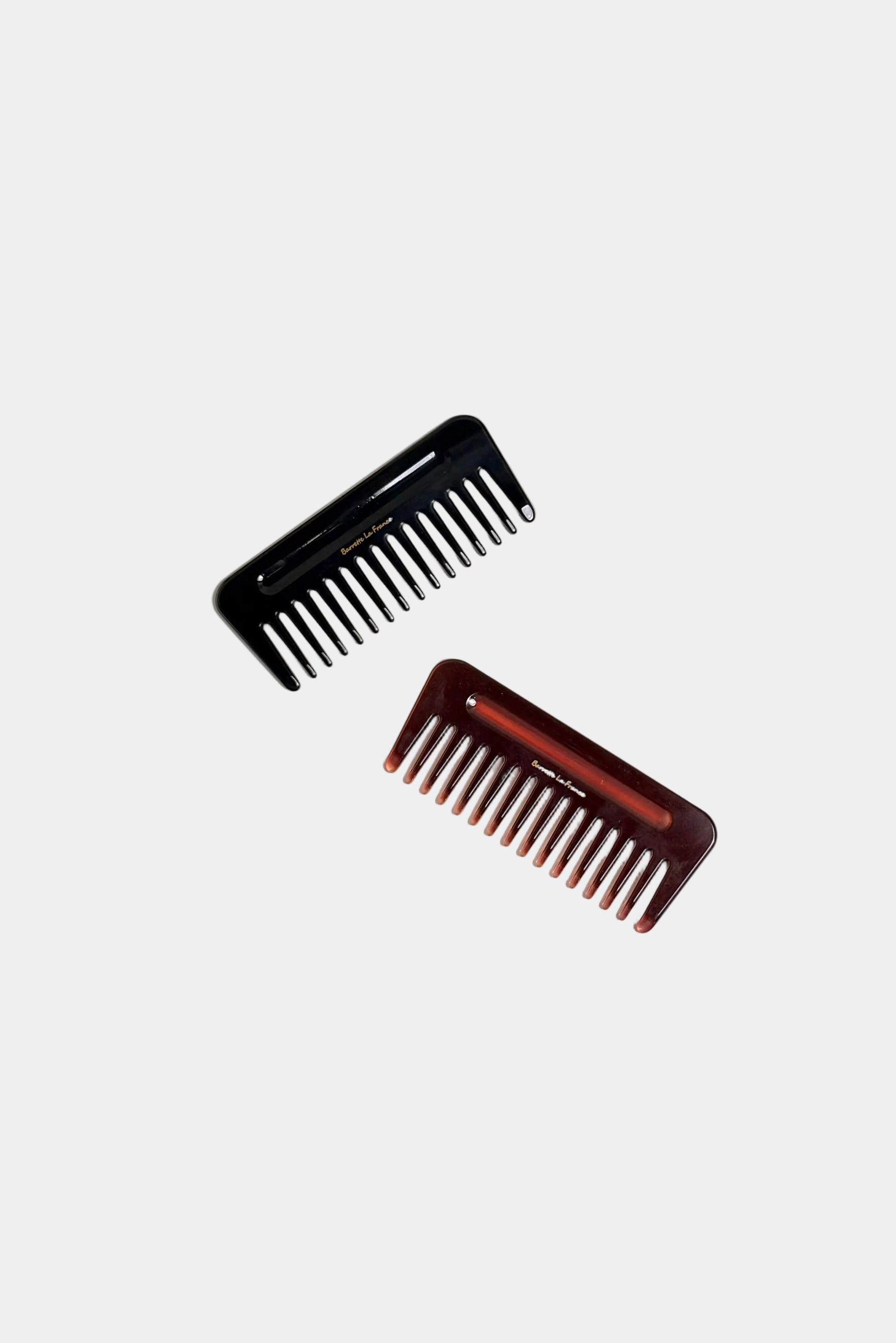 Two hair combs on a beige background