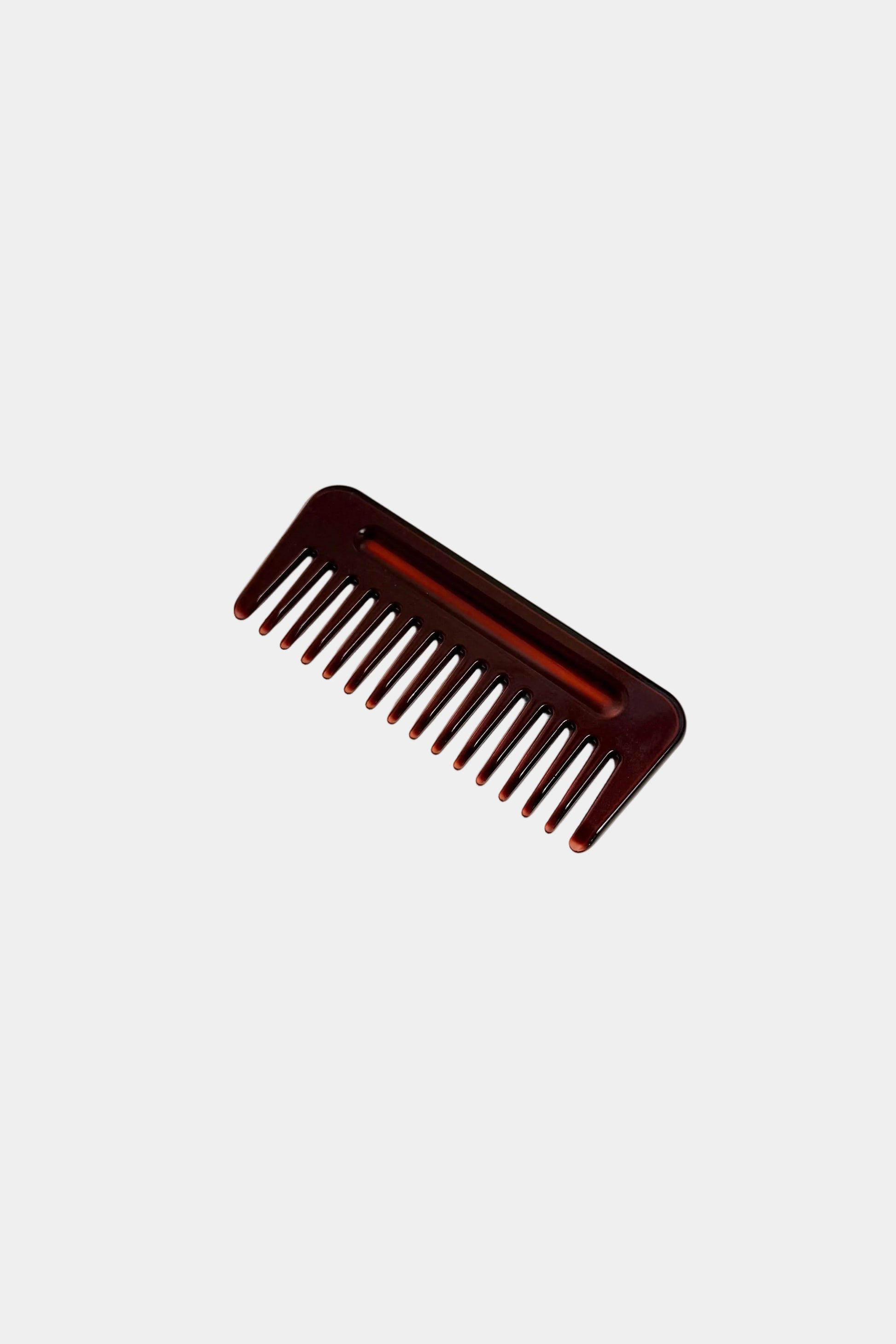 Burgundy comb on a light gray background