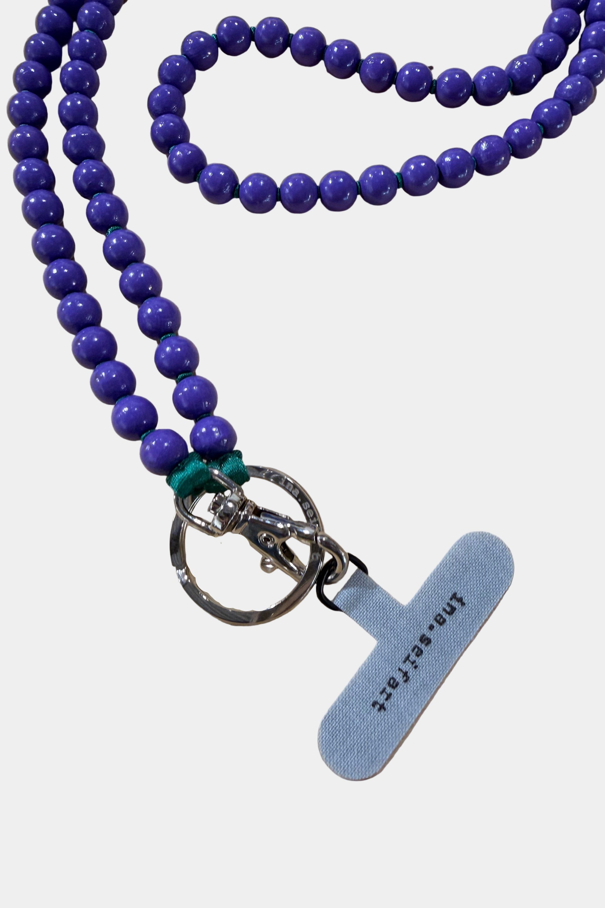 Purple beaded keychain with a metal keyring on a white background