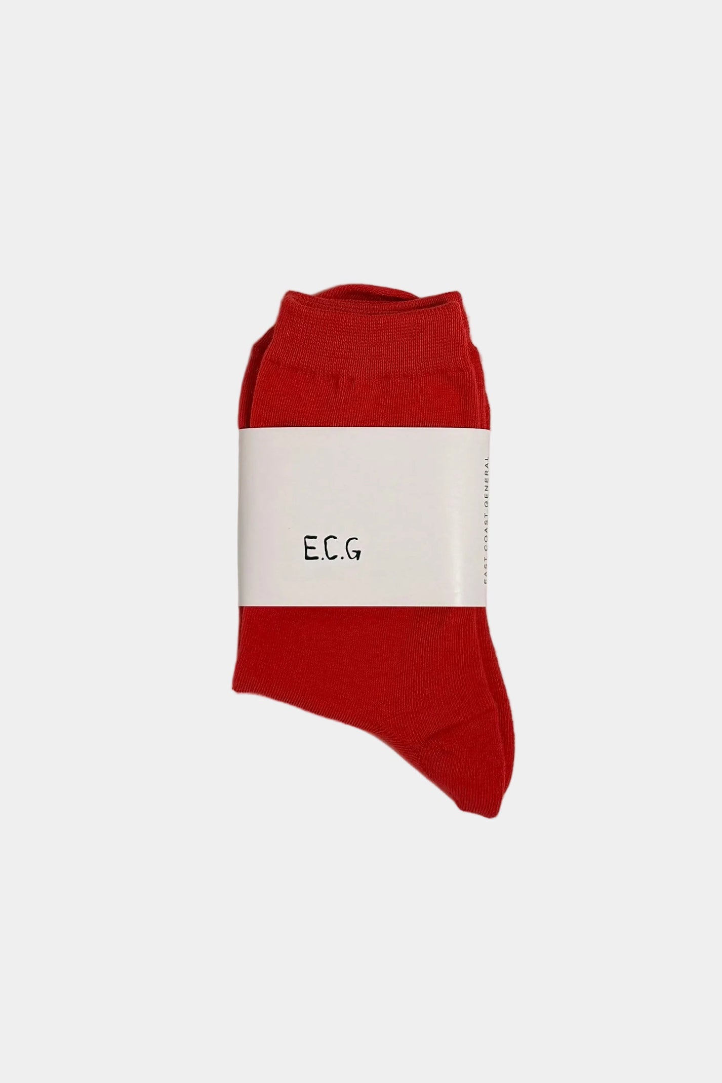 Red cotton socks, folded in hair with a ECG branded band on a white background