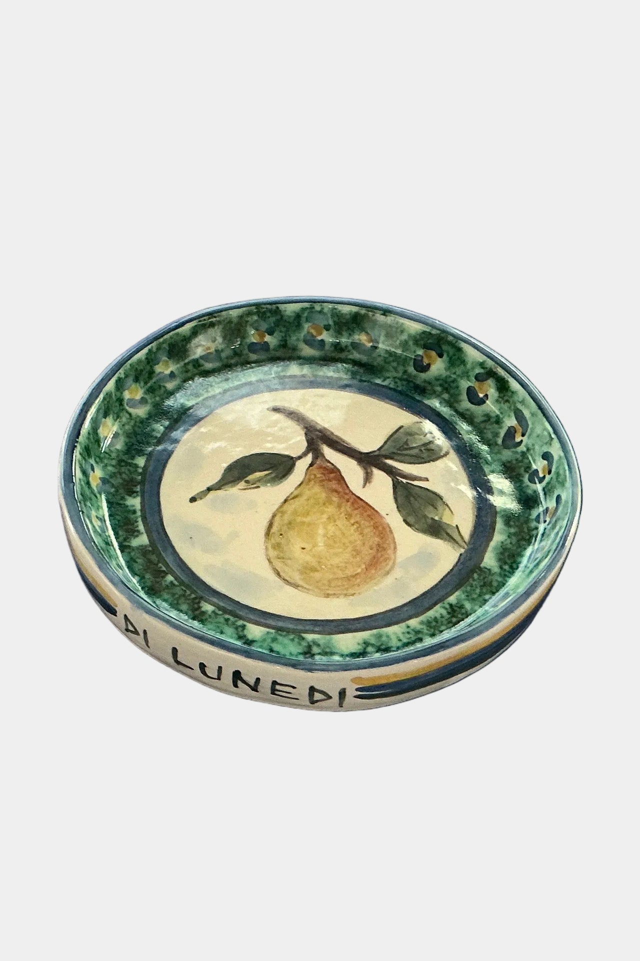 Decorative ceramic plate with a pear design on a plain surface.