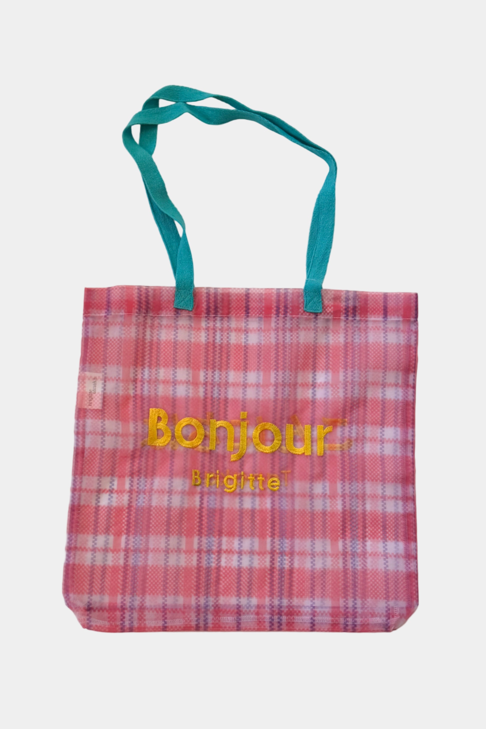 Red plaid tote bag with 'Bonjour' text on a white background