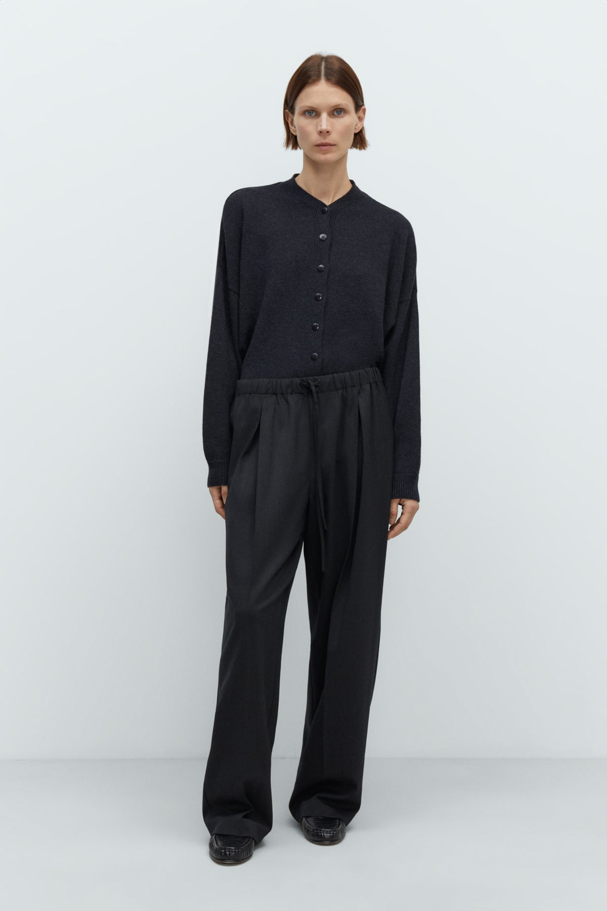 Person wearing a black outfit on a white background