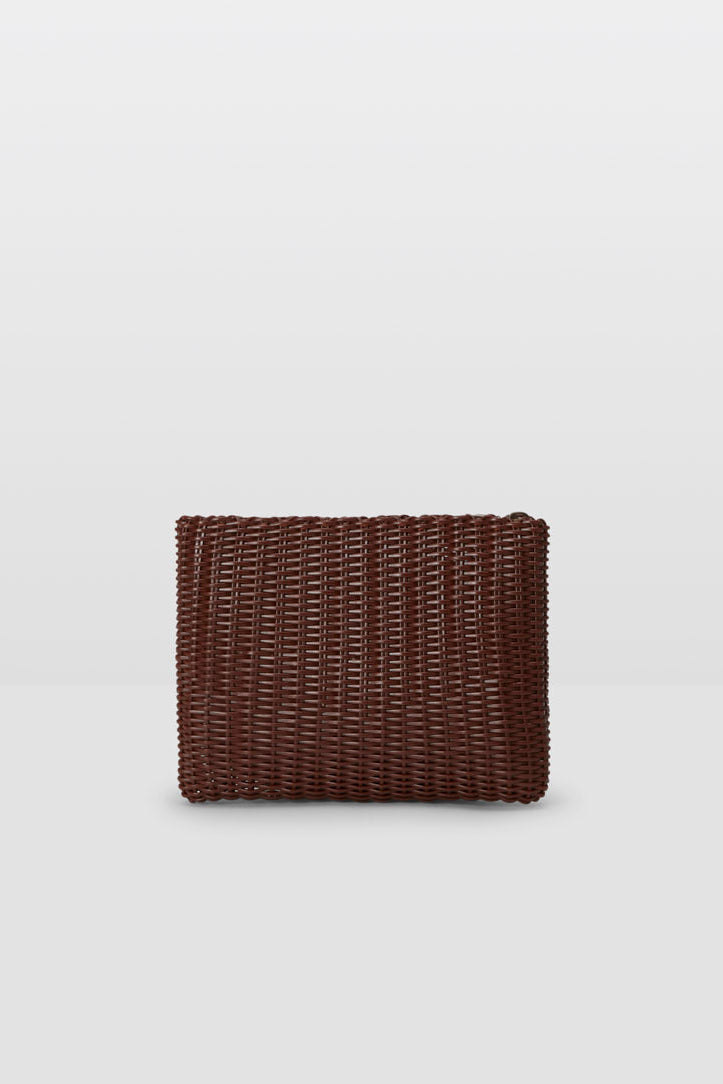 brown woven clutch on a grey background