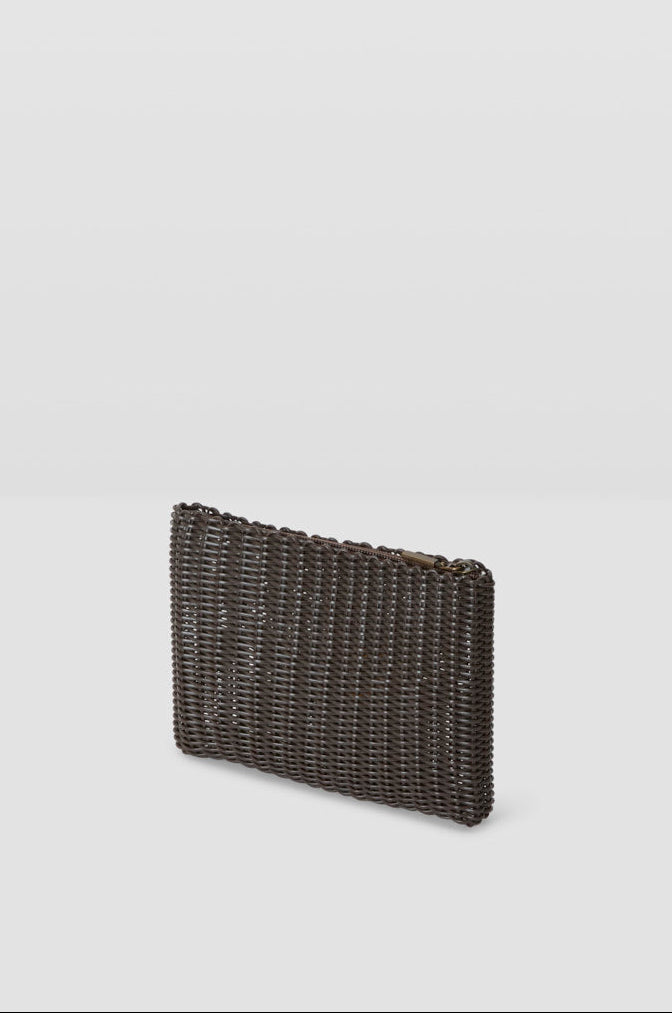 midnight brownwoven clutch bag on a light gray background