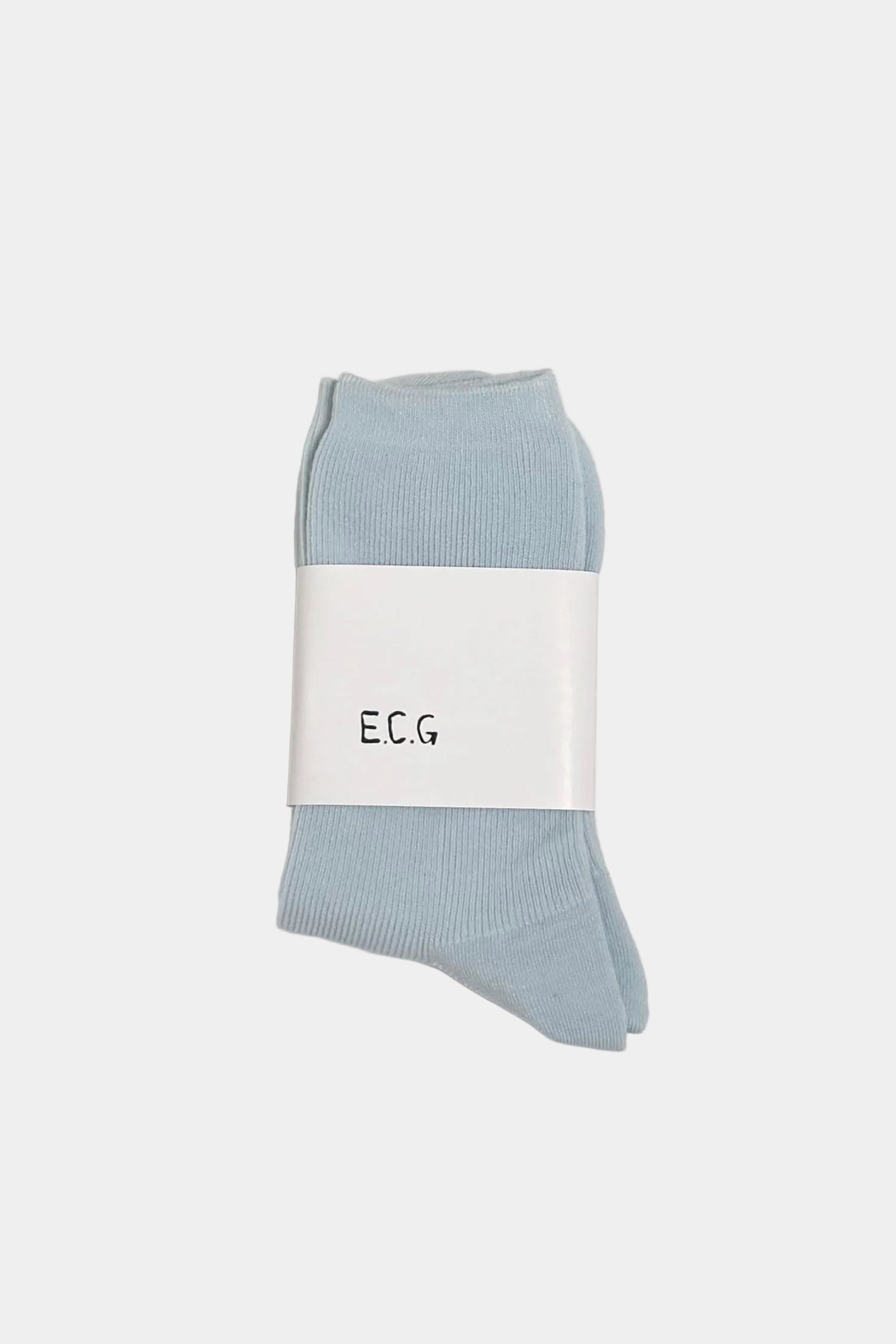 Light blue socks with a white label on a light gray background