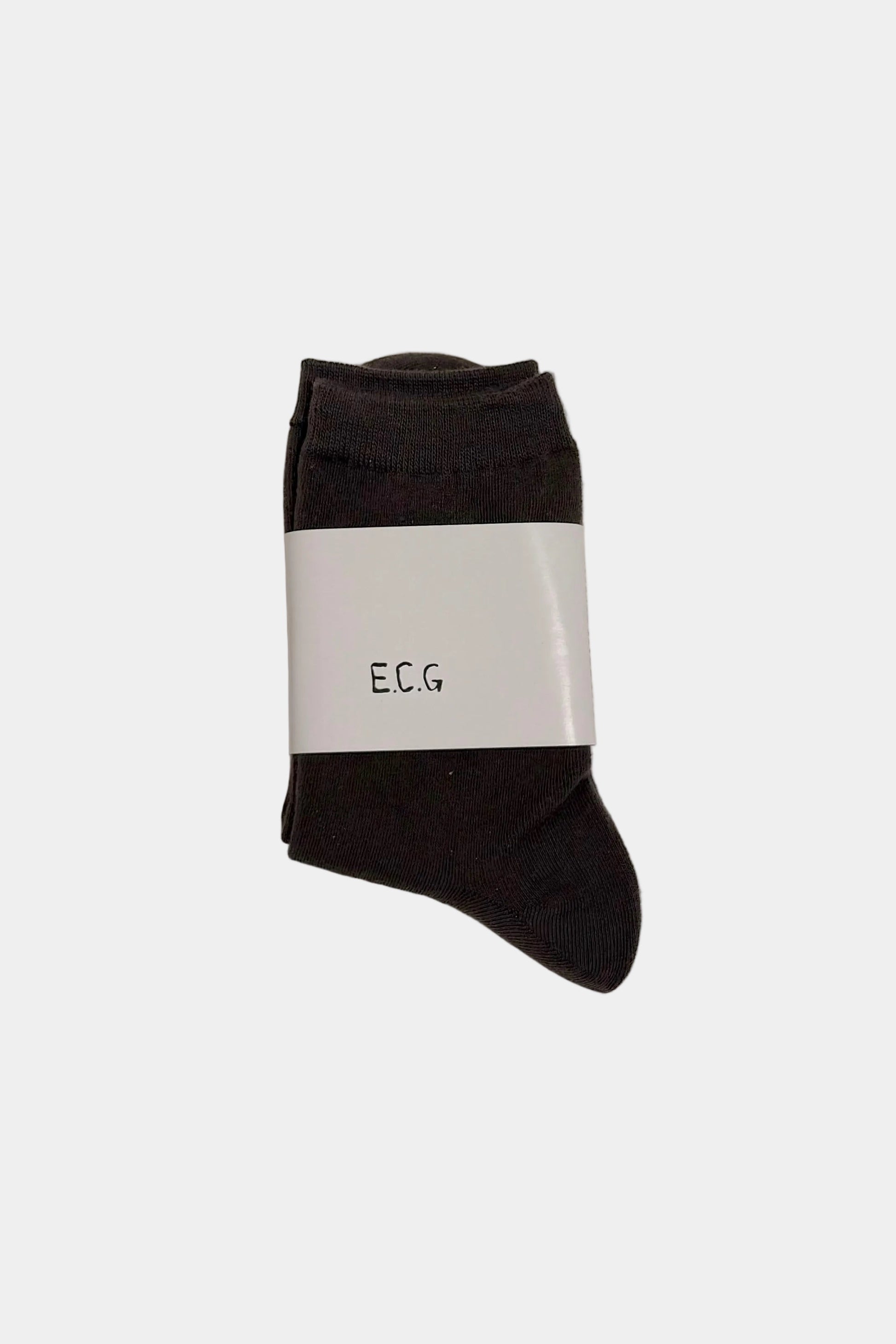 Coffee brown socks with a white label on a light gray background