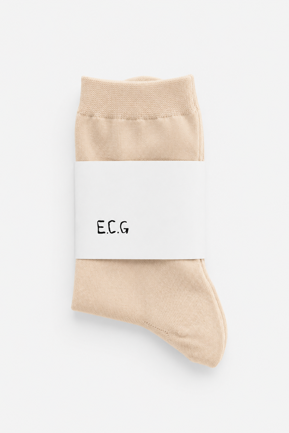 Beige socks with a white label displaying 'E.C.G.' on a light gray background