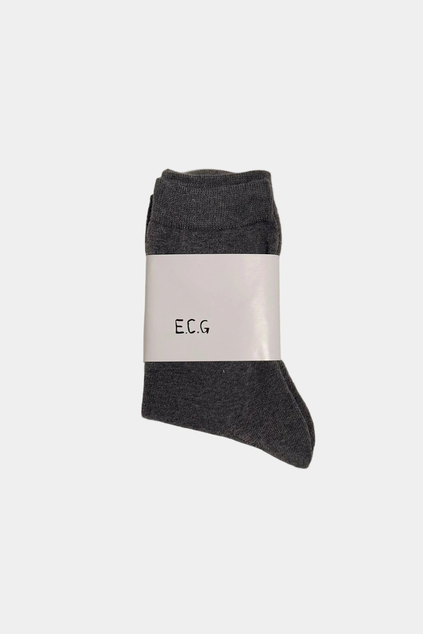 Gray sock with a white label on a beige background