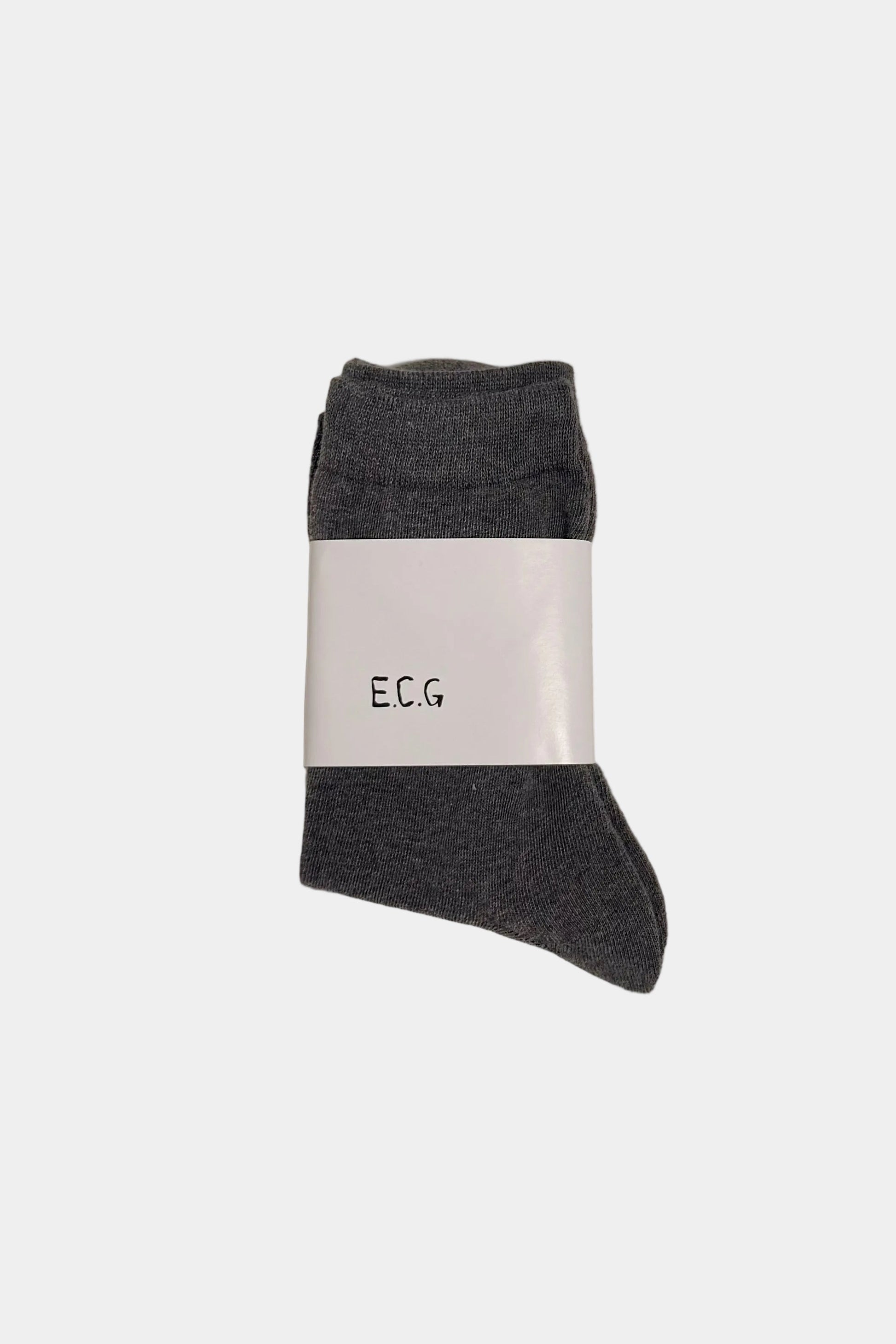 Gray sock with a white label on a beige background