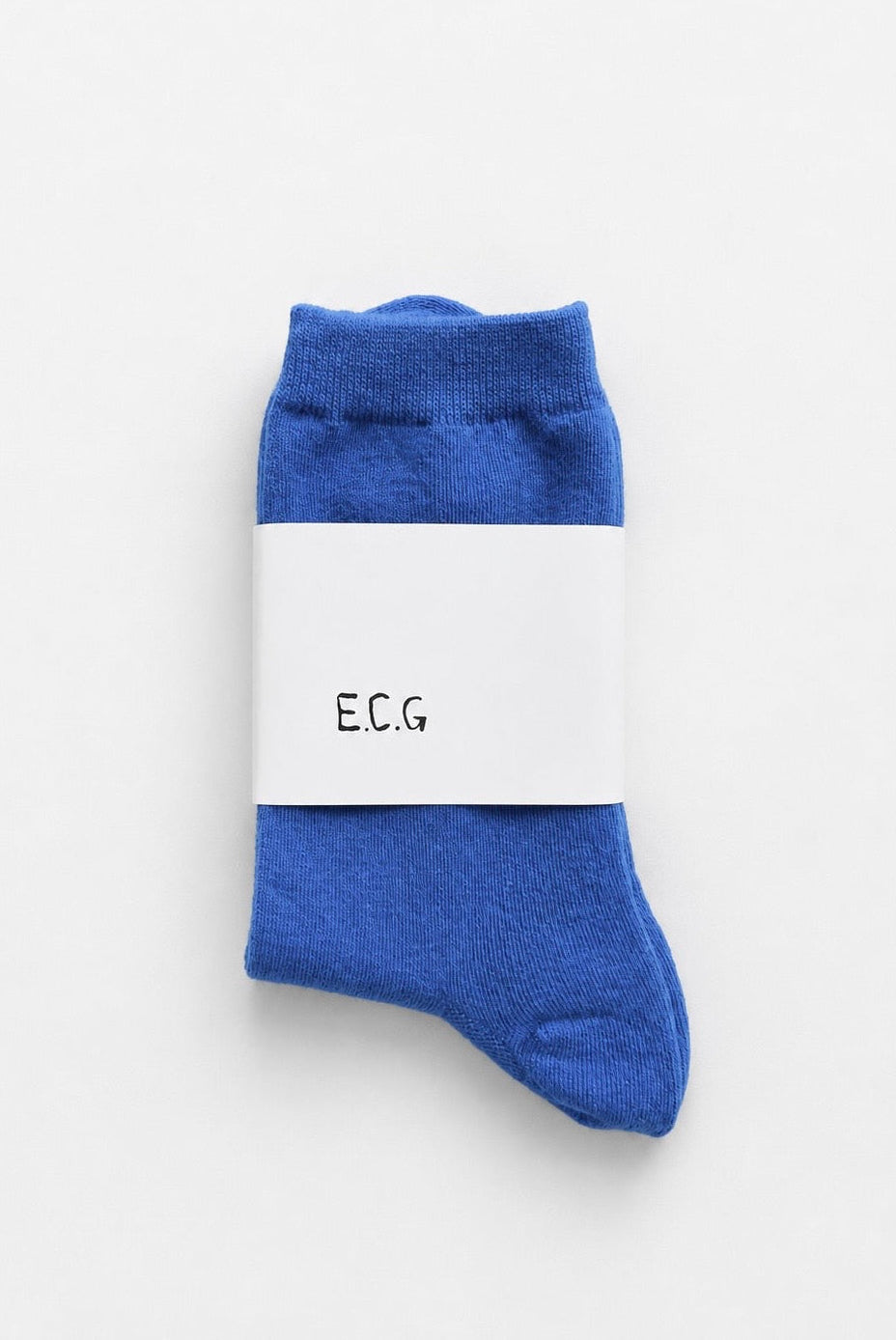 Blue socks with a white label displaying 'E.C.G.' on a light gray background