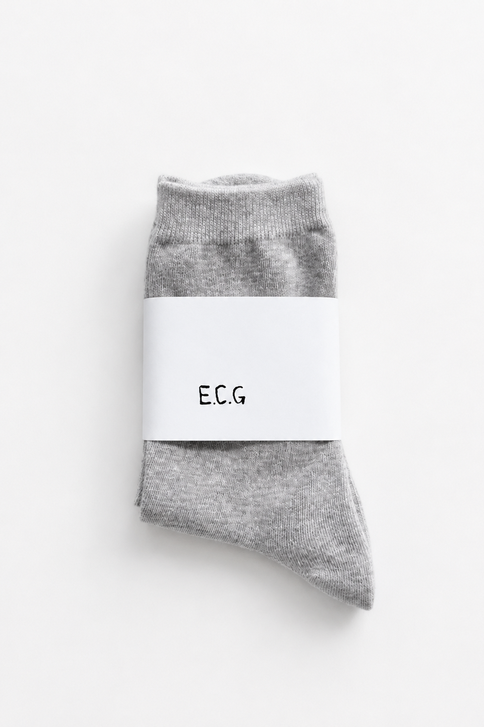 Gray socks with a white label on a white background