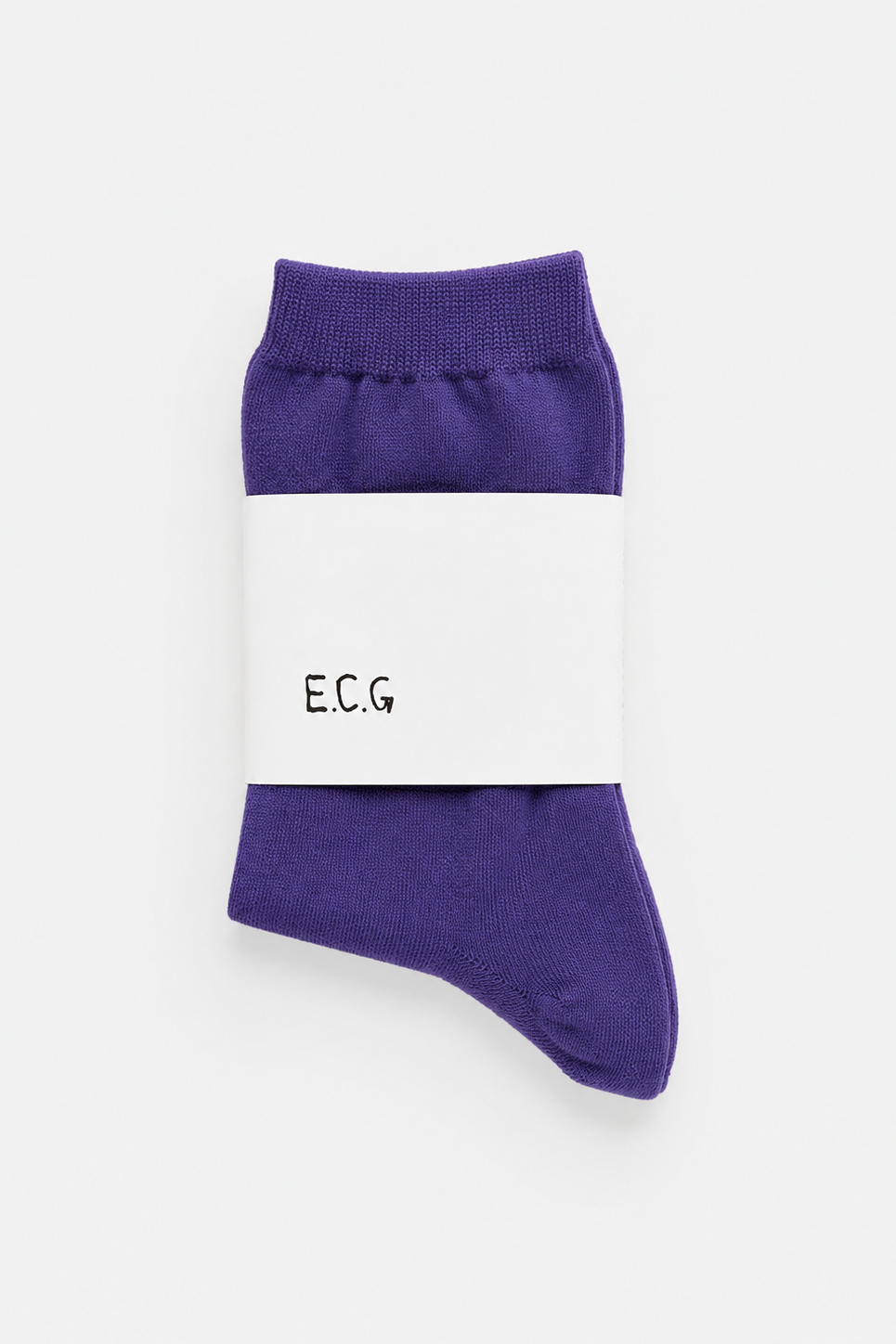 Purple socks with a white label on a light gray background