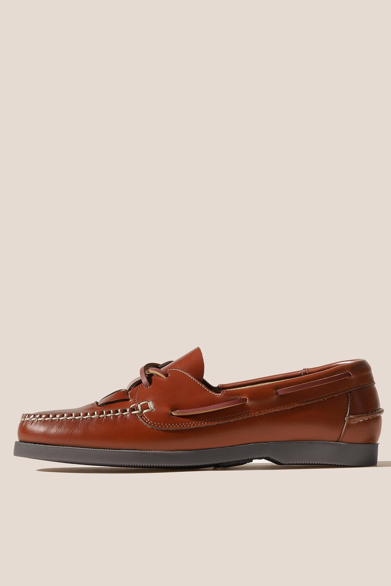 Brown leather loafer shoe on a beige background