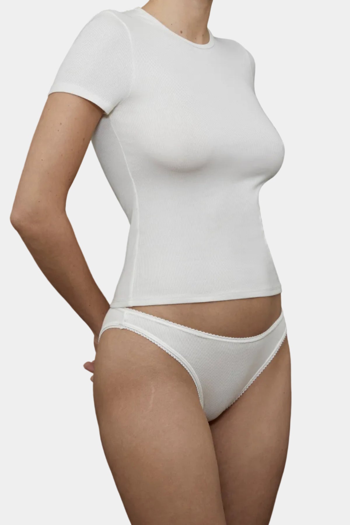 Side profile view of KYE Intimates Natural ribbed short sleeve baby tee