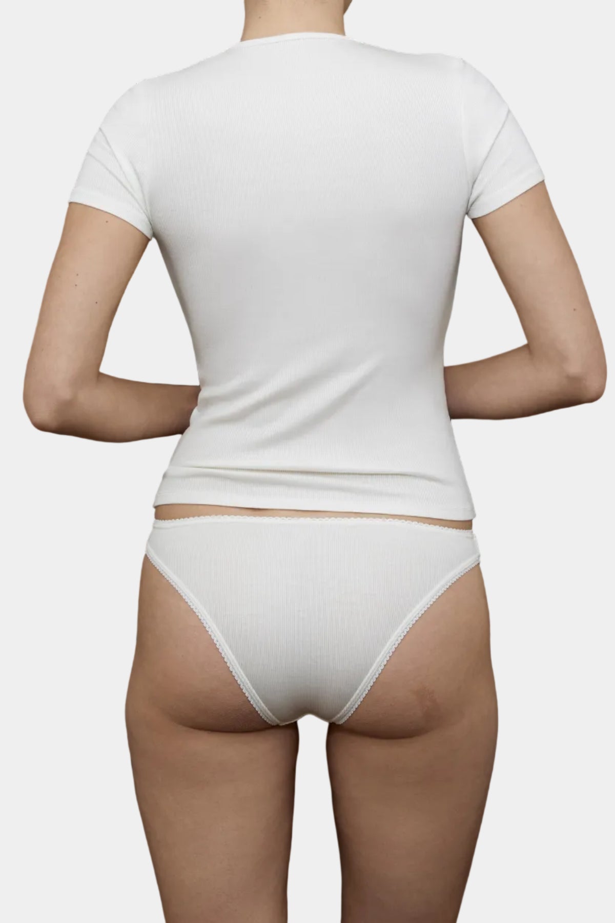 Back view of KYE Intimates Natural ribbed baby tee showing crew neck construction and sleeve cut