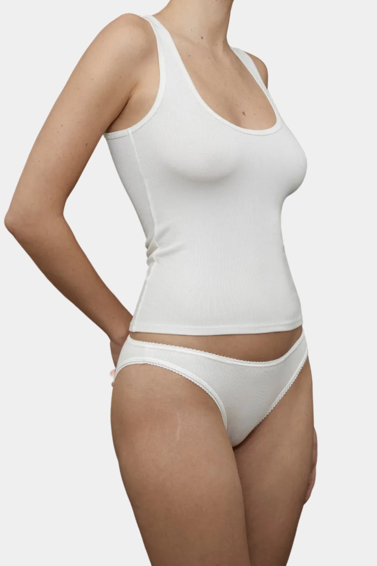 Side profile of KYE Intimates Ivory ribbed racerback tank showing contoured fit