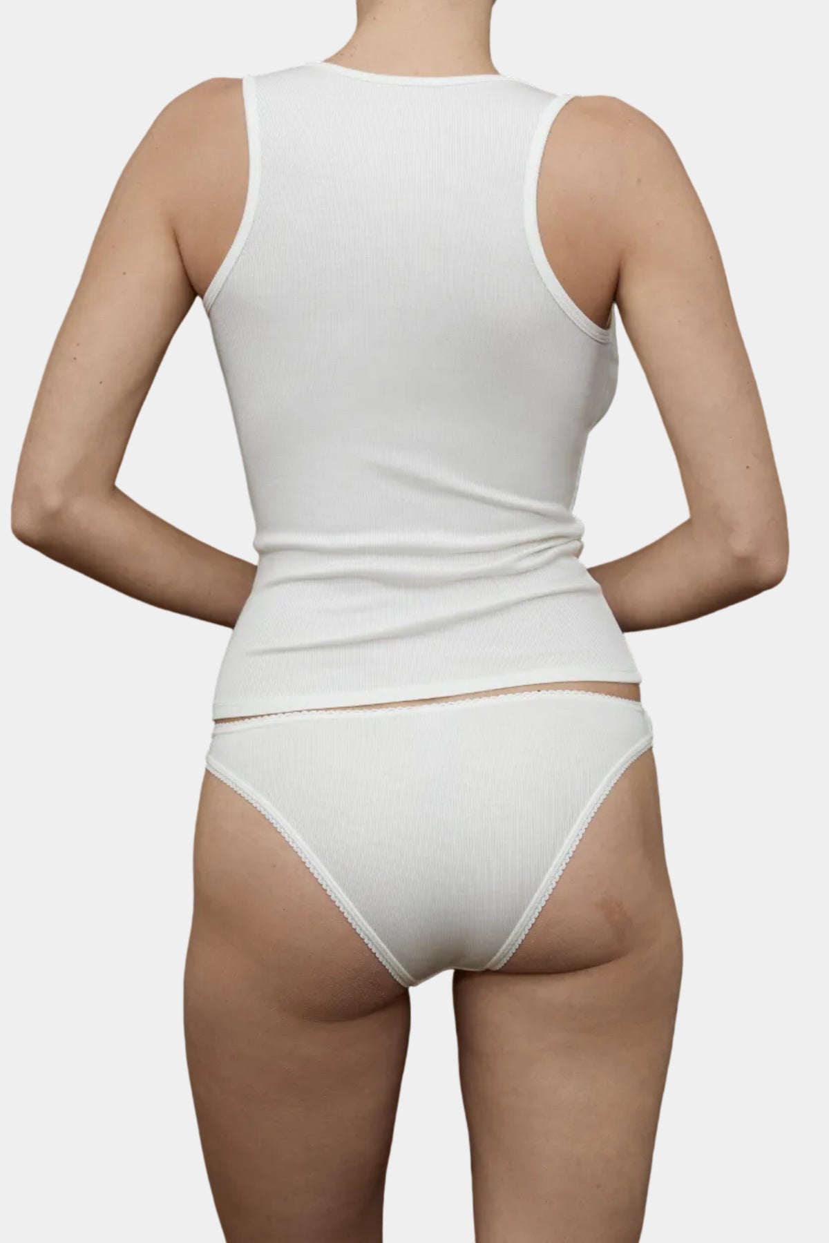 Back view of KYE Intimates Ivory ribbed tank showing racerback detail and fine shoulder straps