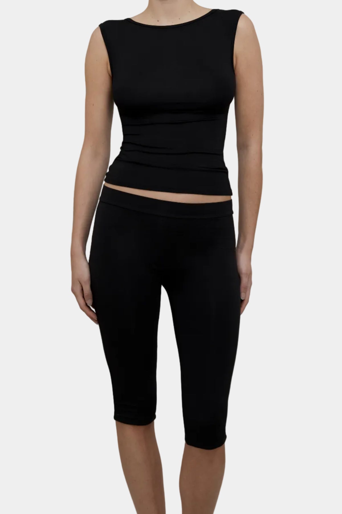 A model wearing Kye Intimates Recline Bateau sleeveless top and matching black capri leggings - East Coast General