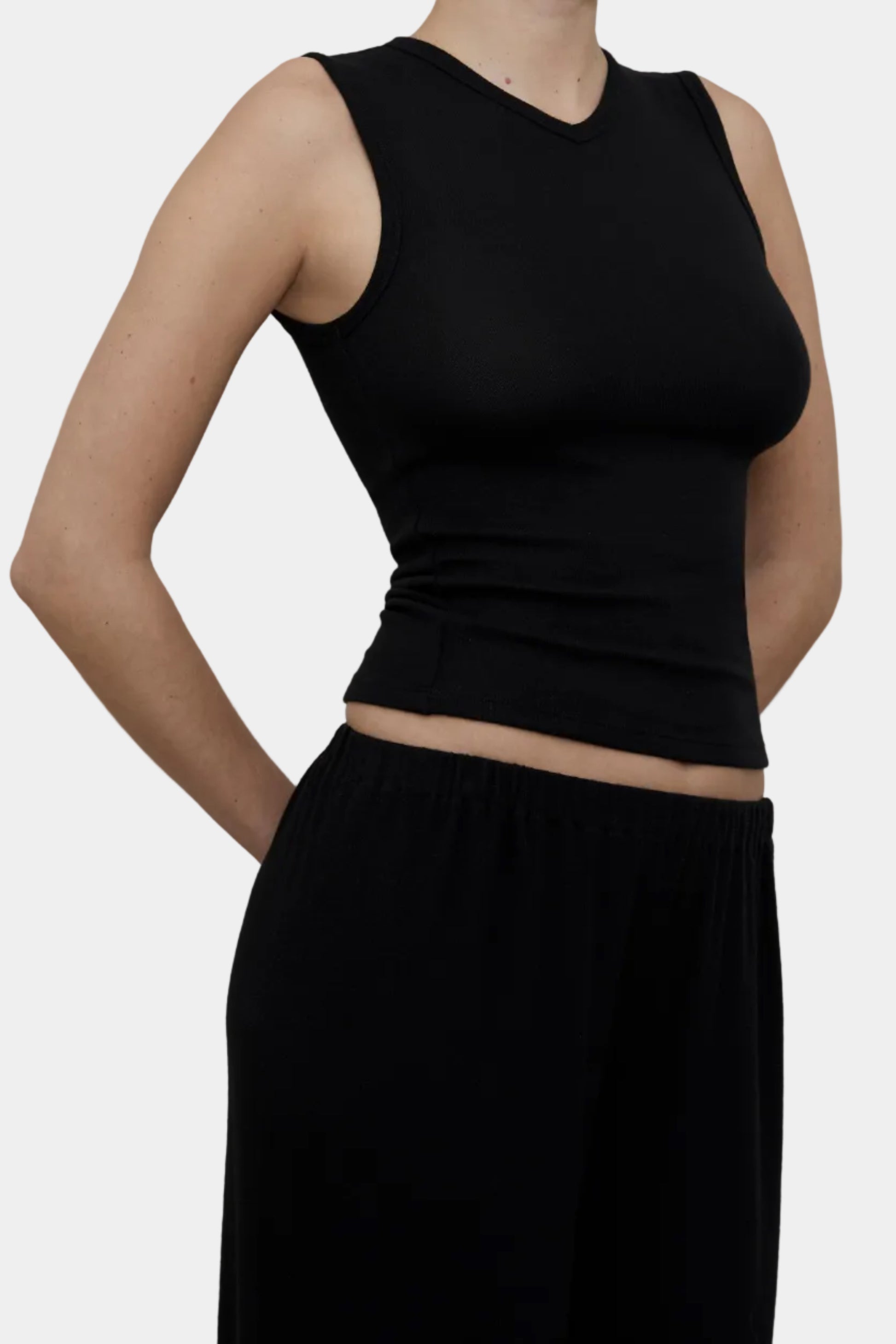 Side profile of KYE Intimates Black Hacci knit Vest showing body skimming fit