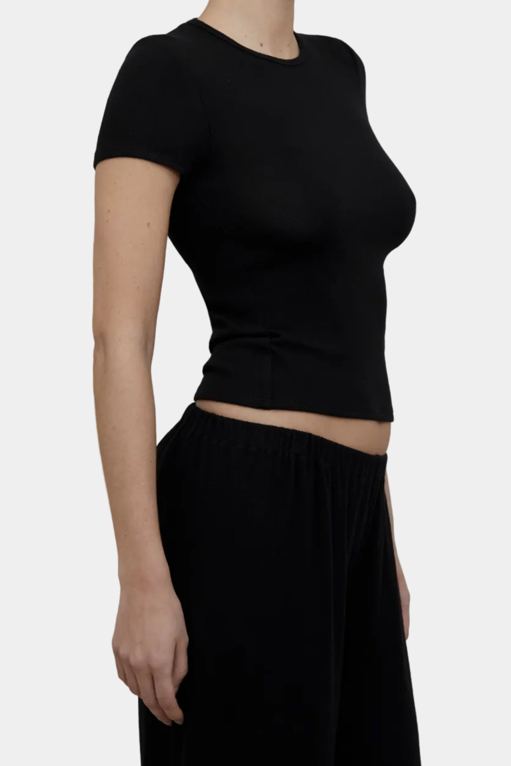 Side profile view of KYE Intimates Black Brushed Hacci Baby Tee showing fitted body-skimming fit