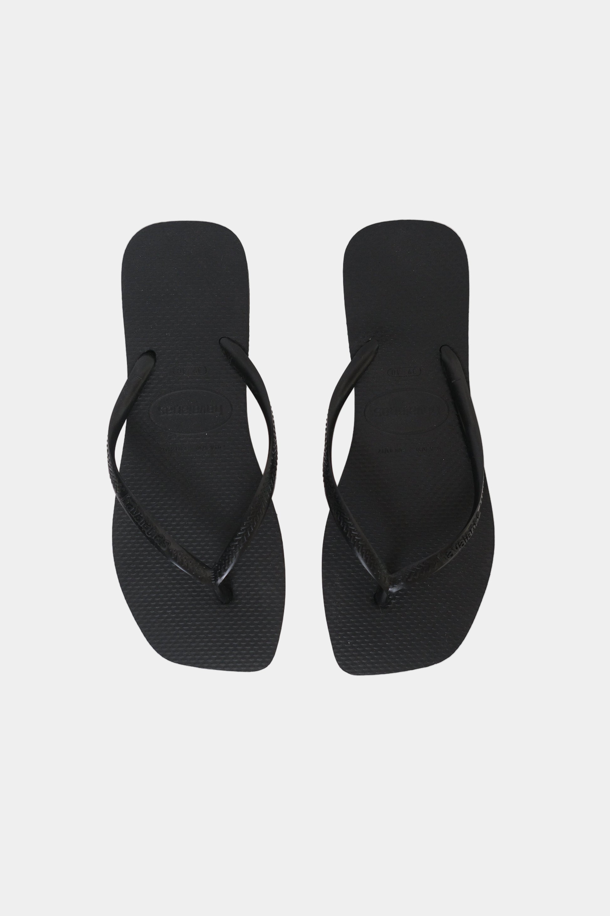 A pair of black Havaianas flip-flops with a square toe shape and slim strap.