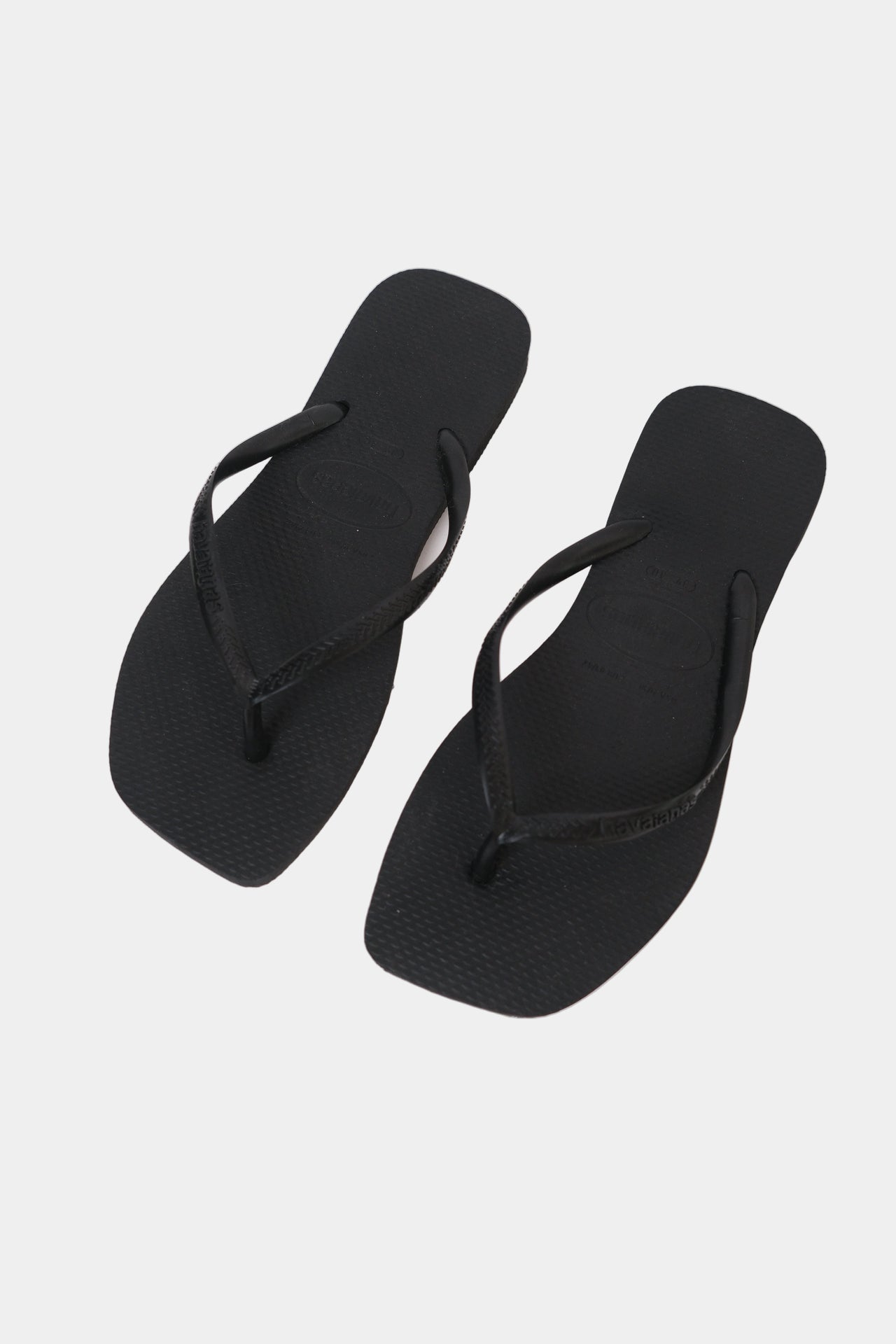 A pair of black Havaianas flip-flops with a square toe shape and slim strap.