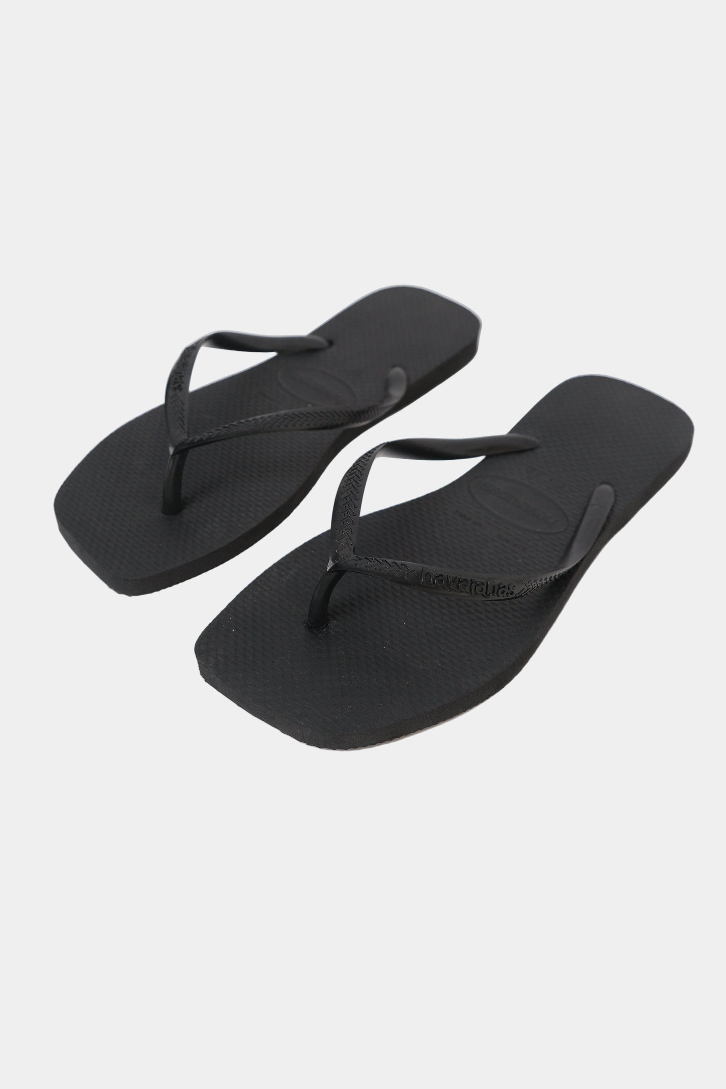 A pair of black Havaianas flip-flops with a square toe shape and slim strap.